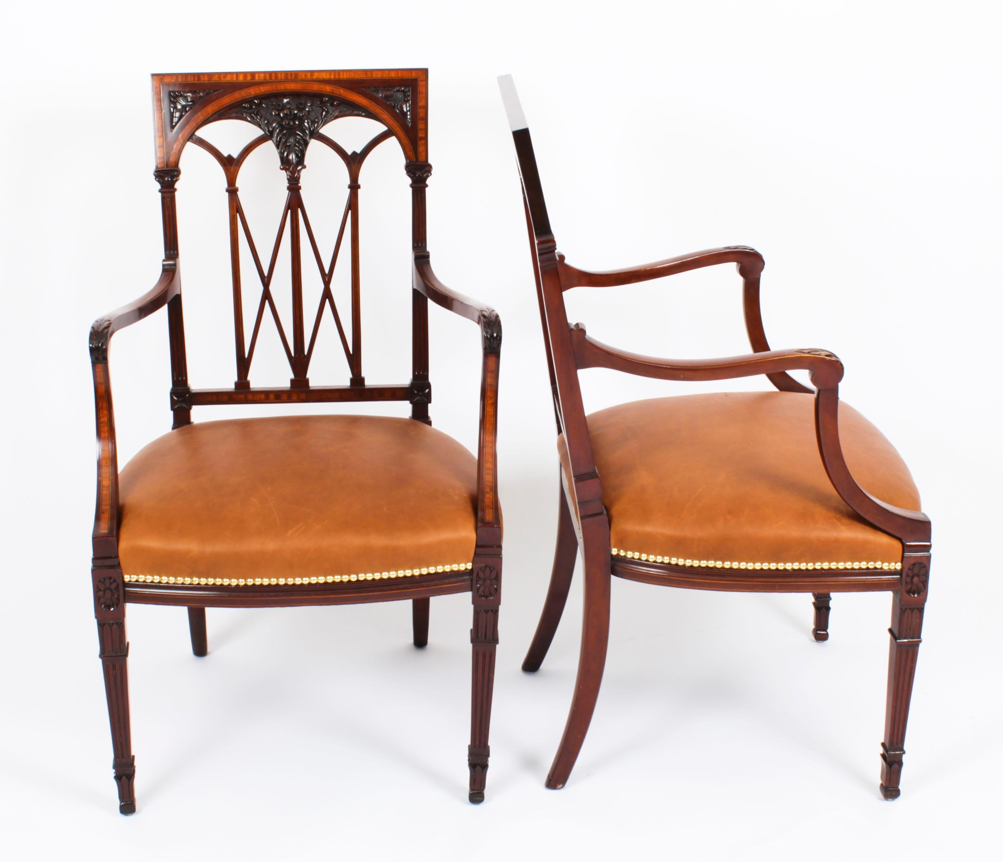 A superb and striking pair of satinwood banded armchairs, in Sheraton Revival taste, Circa 1880 in date.
 
The high back arm chairs feature satinwood banding with boxwood and ebonised line inlay and wonderful foliate carved decoration. The square