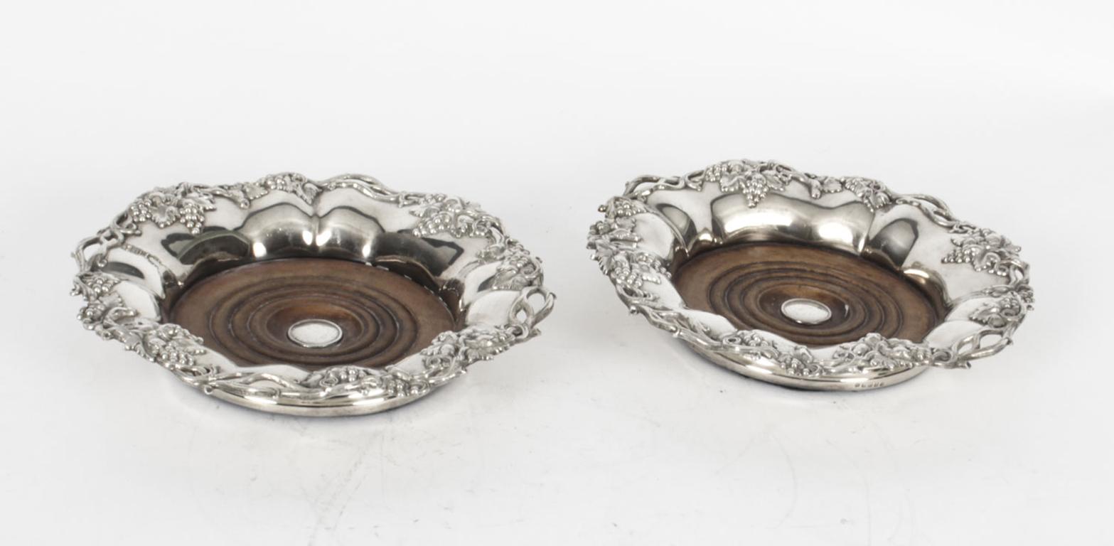 A superb antique pair of silver plated wine coasters bearing the makers mark of William Howe & Co, and dating from the mid 19th Century.

The shaped circular wine coasters feature exquisite vine and grape borders with pierced decoration, with floral