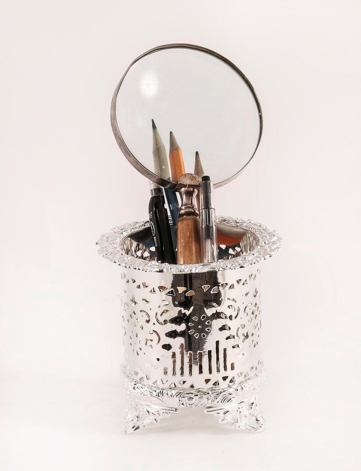 A very attractive pair of silver plated wine coasters with superb pierced and embossed decoration, bearing the impressed makers mark, JD, on the base, and dating from Circa 1920.

A highly versatile pair which could also serve as grandiose pen