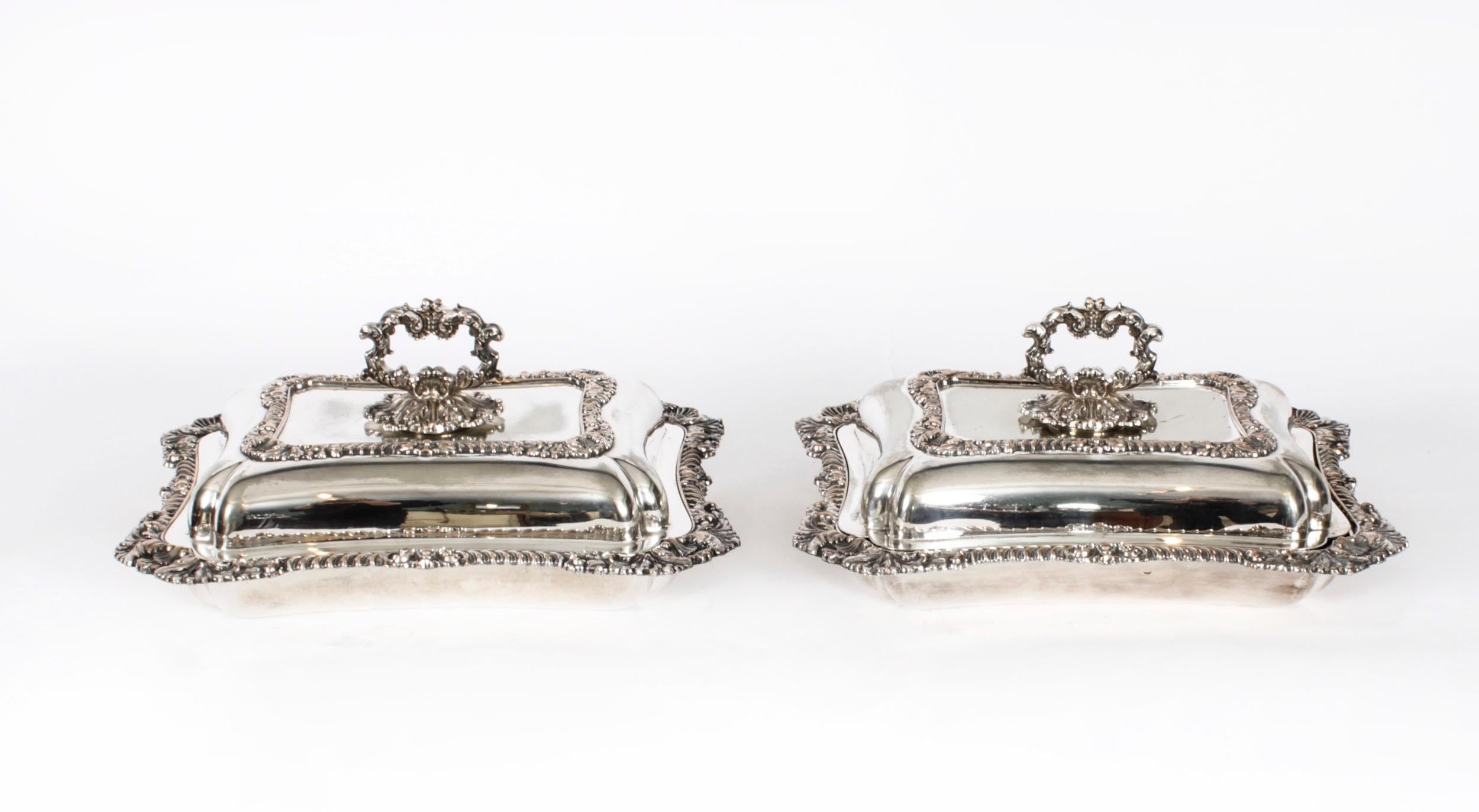 This is an exquisite and rare antique pair of English silver plated on copper entree dishes stamped Walker & Hall Sheffield Plate Old Style, and dated Circa 1860.
 
The dishes are of rectangular shaped form with gaddrooned and acanthus leaf borders