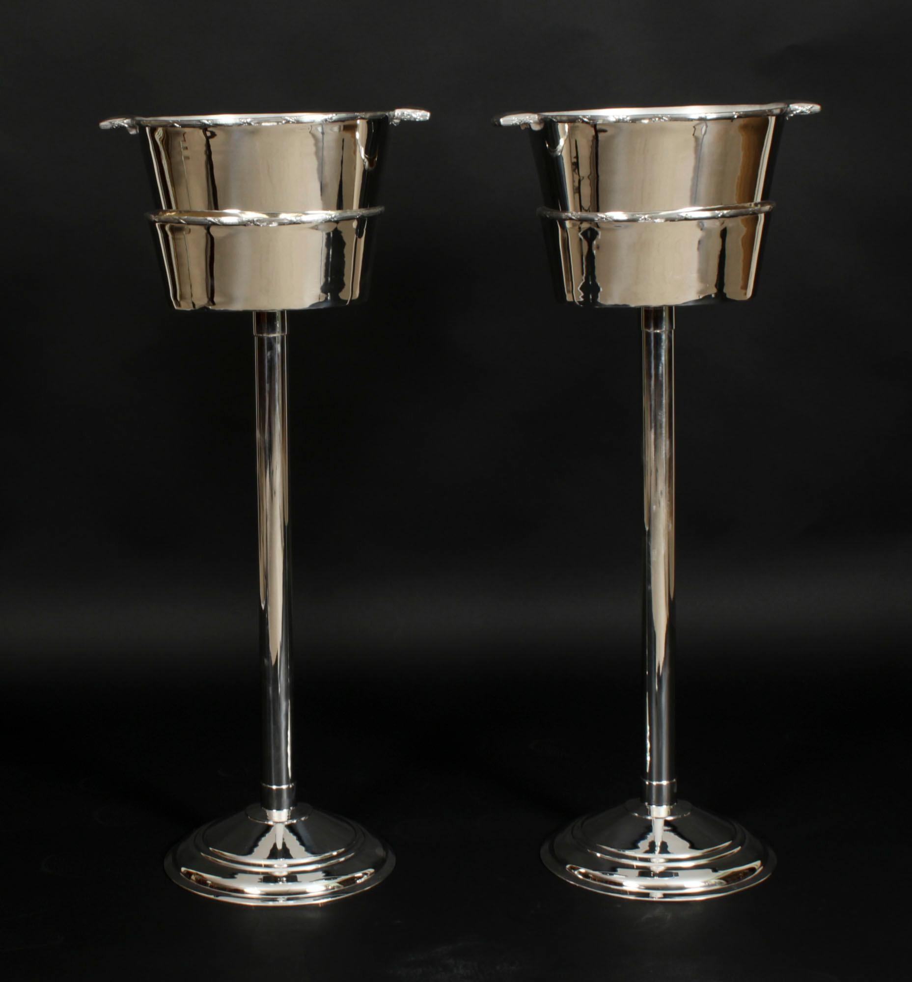 This is a fabulous antique pair of silver plated champagne coolers on stands bearing the makers mark of the renowned silversmith,  Mappin & Webb, circa 1900 in date.

They are of beautiful design and are elegant and contemporary at the same