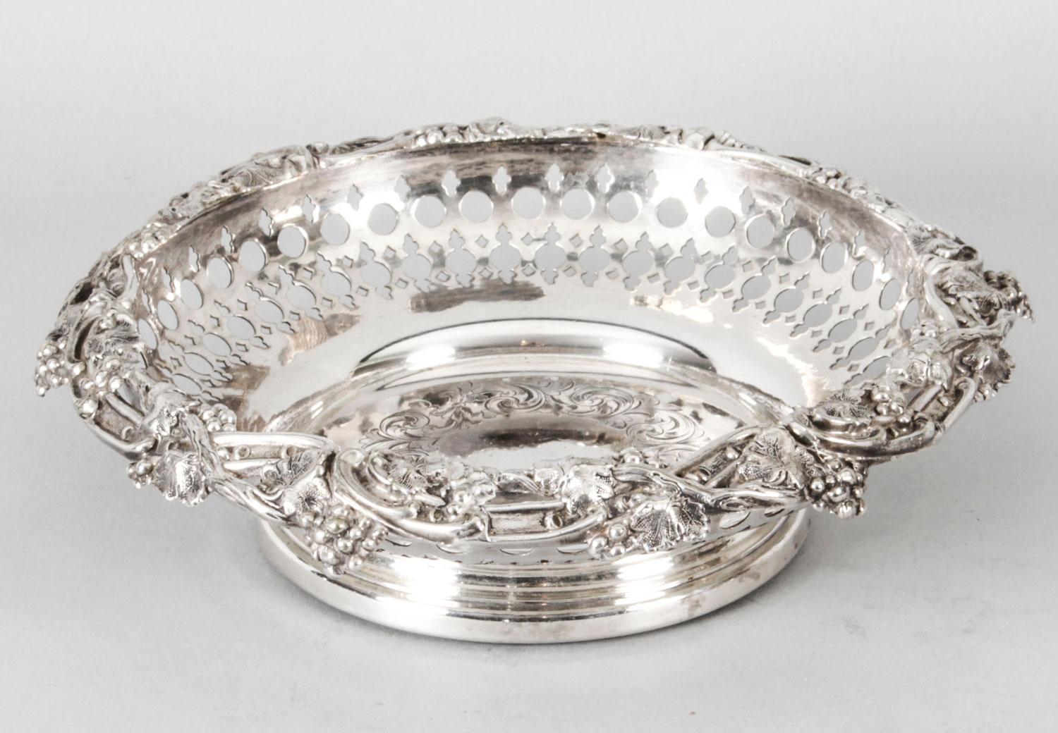 This is a very attractive English pair of antique silver plated bottle coasters by the renowned silversmith Henry Waterhouse, circa 1870 in date.

The circular shaped wine coasters feature exquisite vine and grape borders with pierced decoration