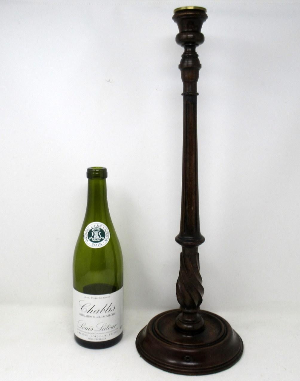 An exceptionally fine quality stylish solid walnut towering pair of turned and carved single light candlesticks of unusually tall proportions, late 19th-early 20th century, possibly of English origin. 

Each modelled in the Louis XVI style with