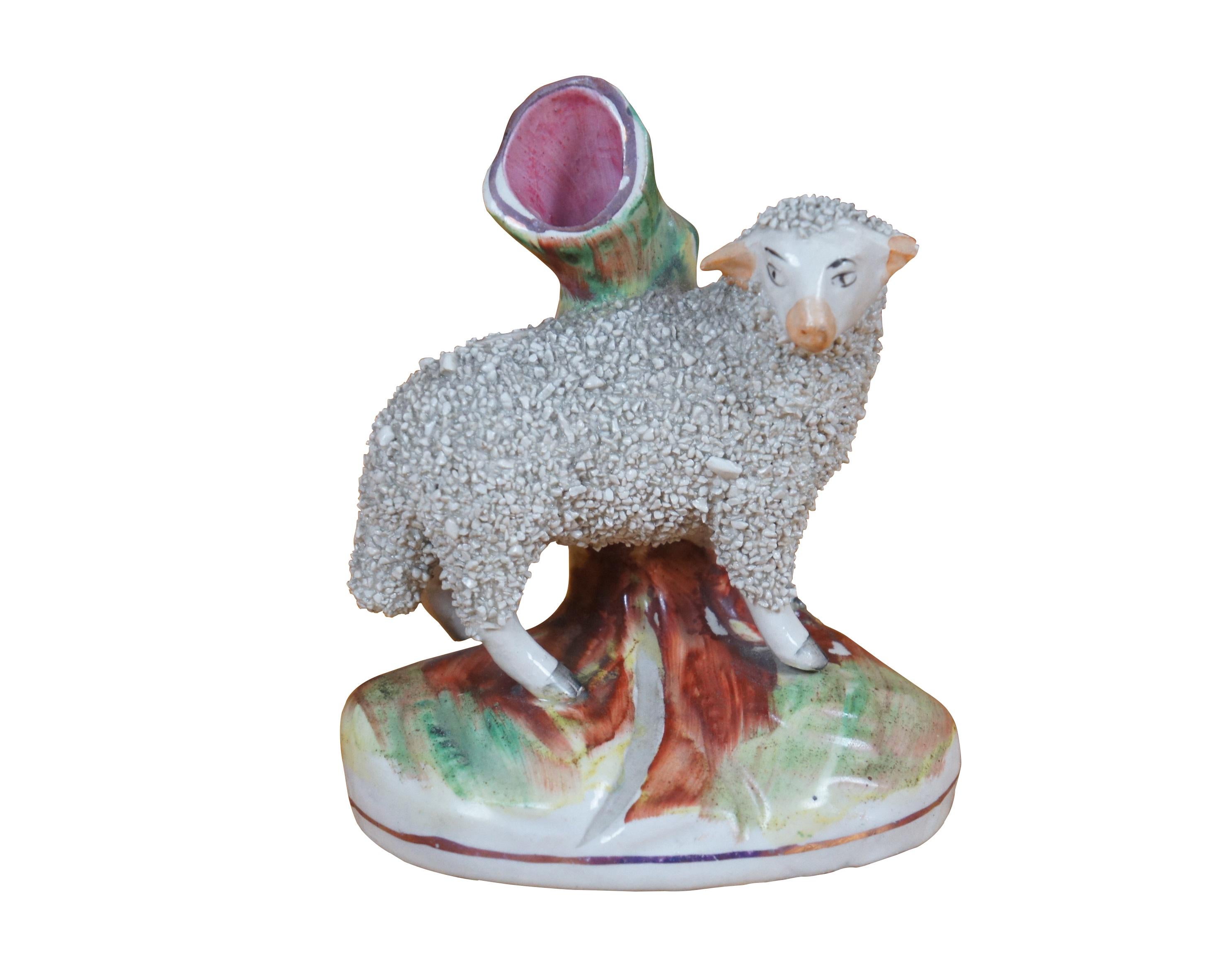 Antique 19th century English Staffordshire porcelain figural bud vases in the shape of sheep / lamb - ram and ewe - with confetti fleece, standing before small tree stumps.

Dimensions:
4.25