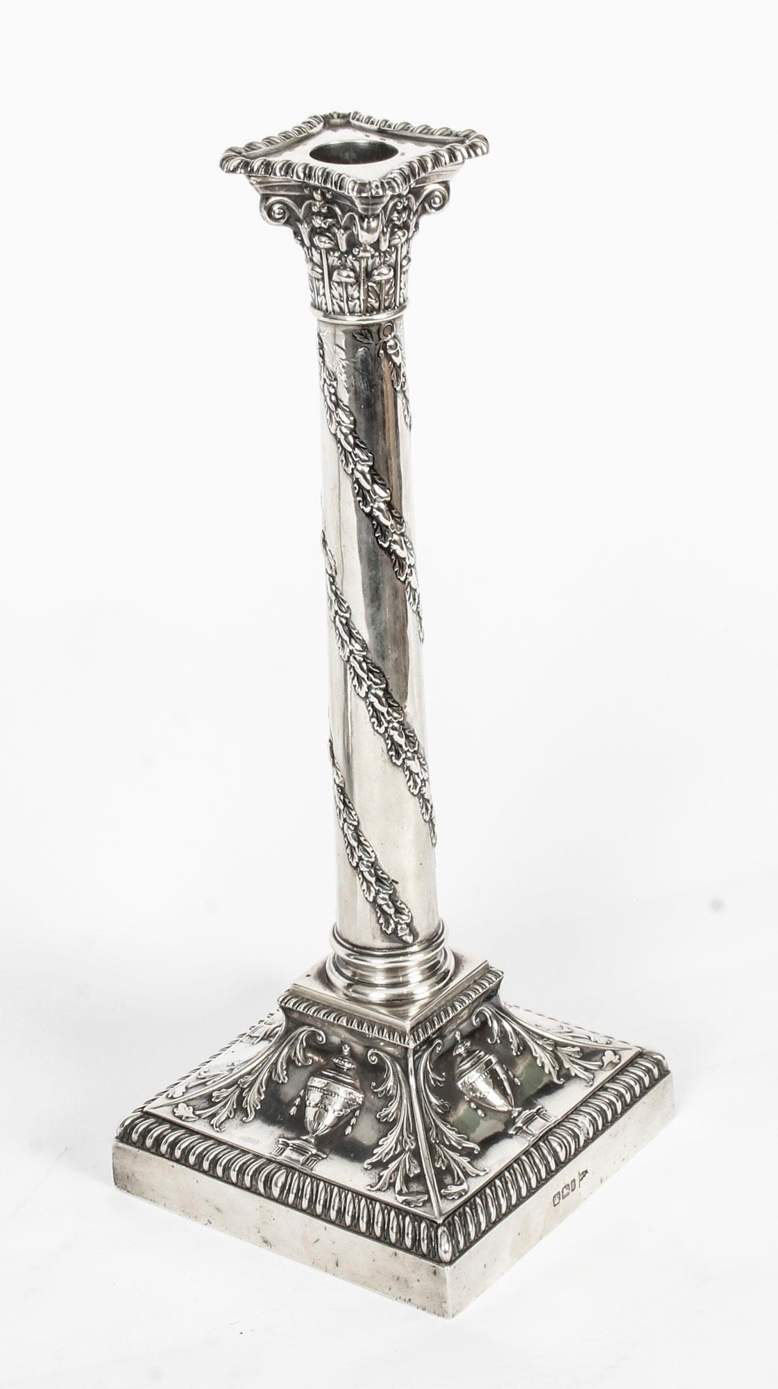 This is an exquisite pair of English antique neoclassical design sterling silver candlesticks bearing hallmarks for Sheffield, dated 1900 and the makers mark of the renowned silversmith Walker and Hall.
 
The candlesticks feature exquisite reeded
