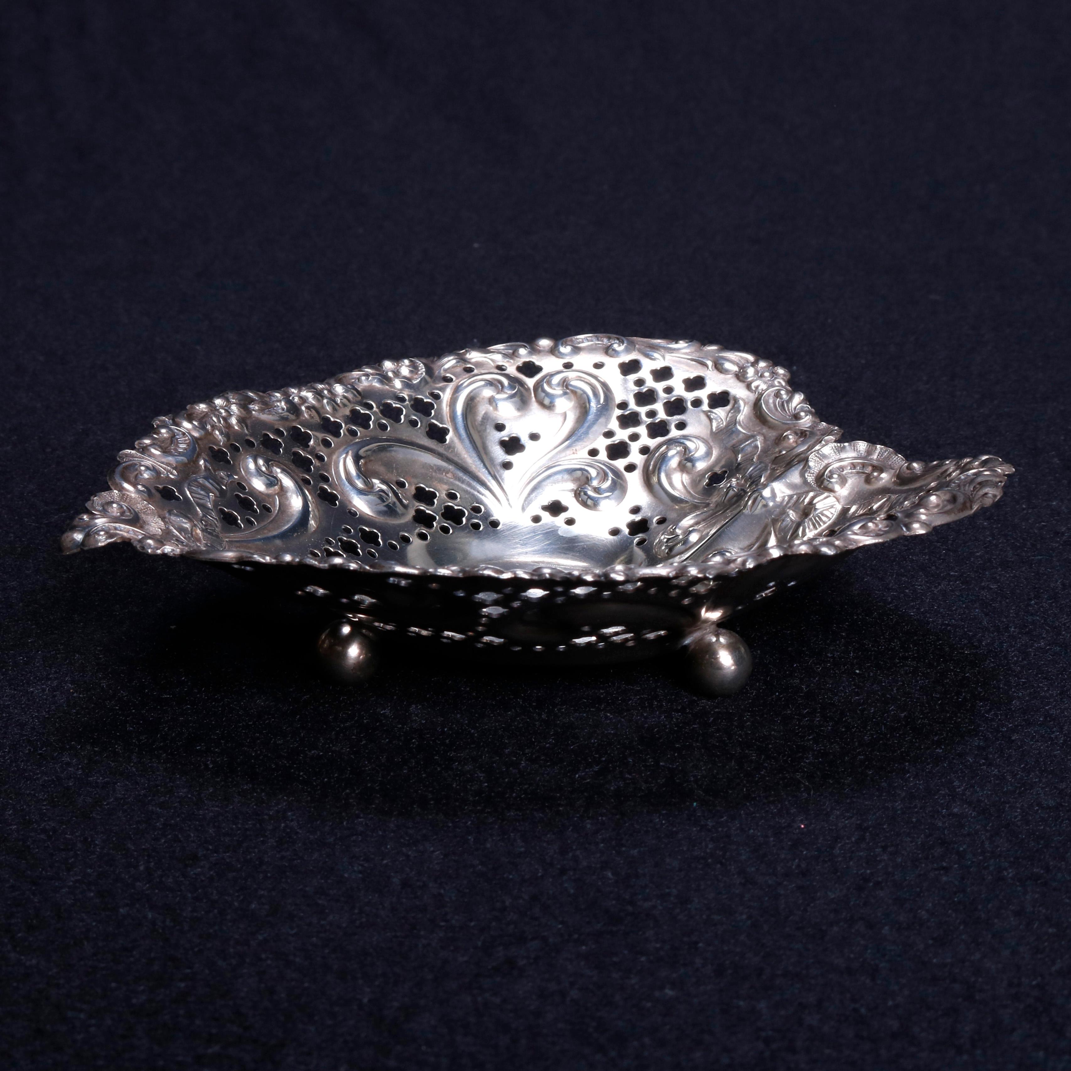Antique Gorham sterling silver nut or candy dishes feature reticulated heart shaped bowls with scroll and foliate designing, seated on ball feet, en verso maker mark as photographed, circa 1890

Measures: 1.25