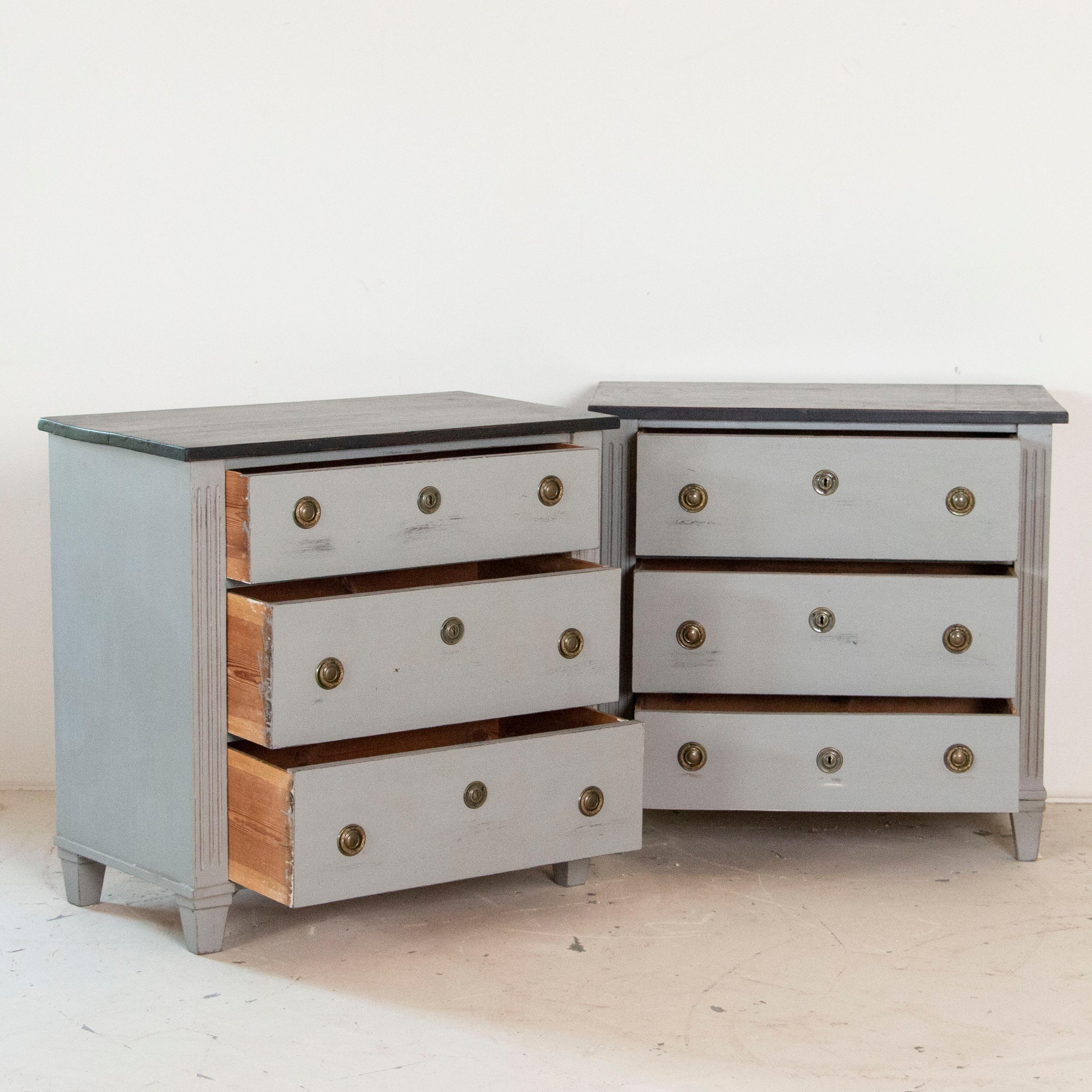 Finding a matched pair of nightstands can be challenging, which makes this pair of Gustavian style chest of drawers an excellent find. Both have simple, clean lines and were painted later with soft gray paint and black tops, fitting of their Swedish