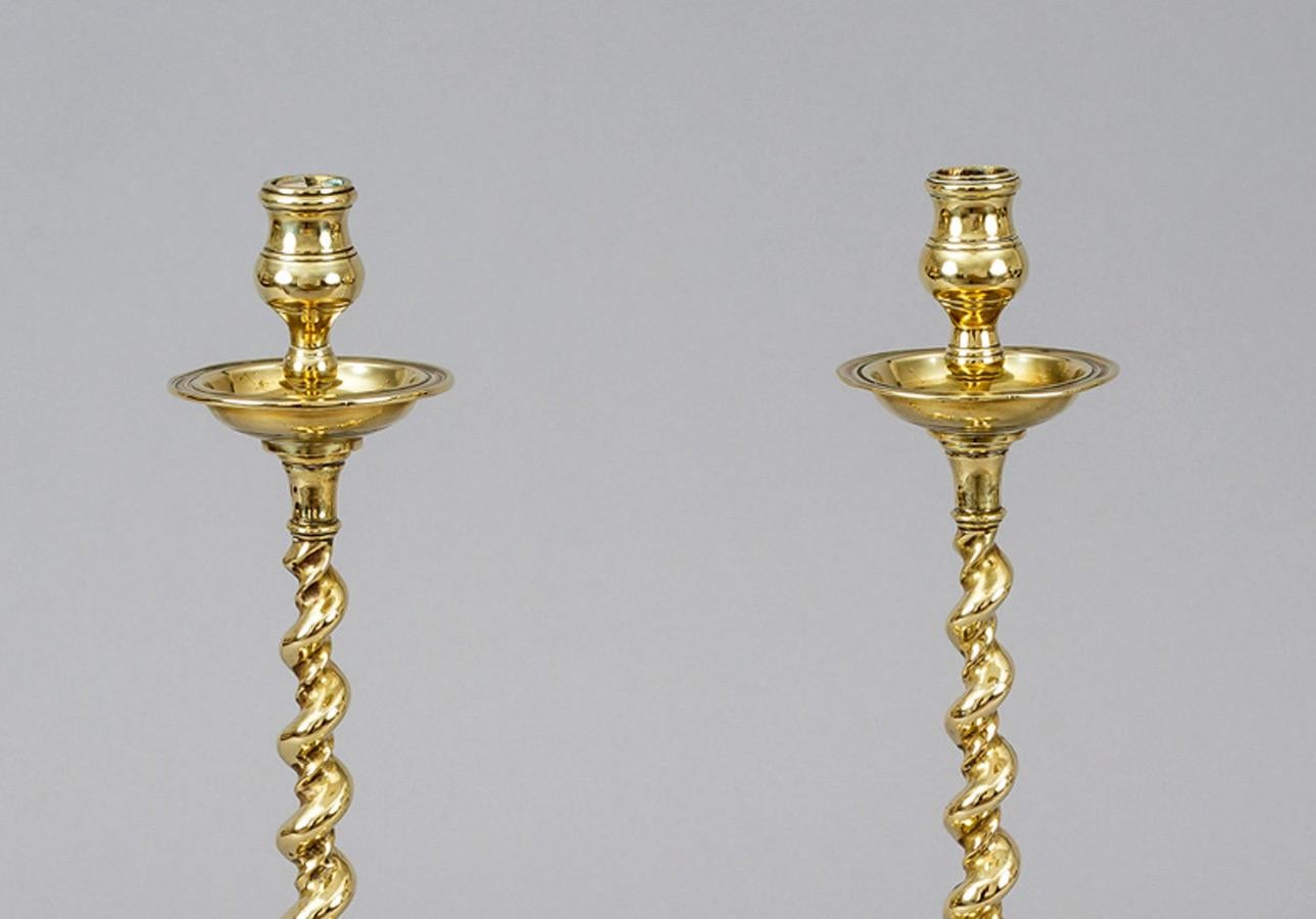 Antique pair of very tall brass candlesticks with a spiral twist column on turned base.