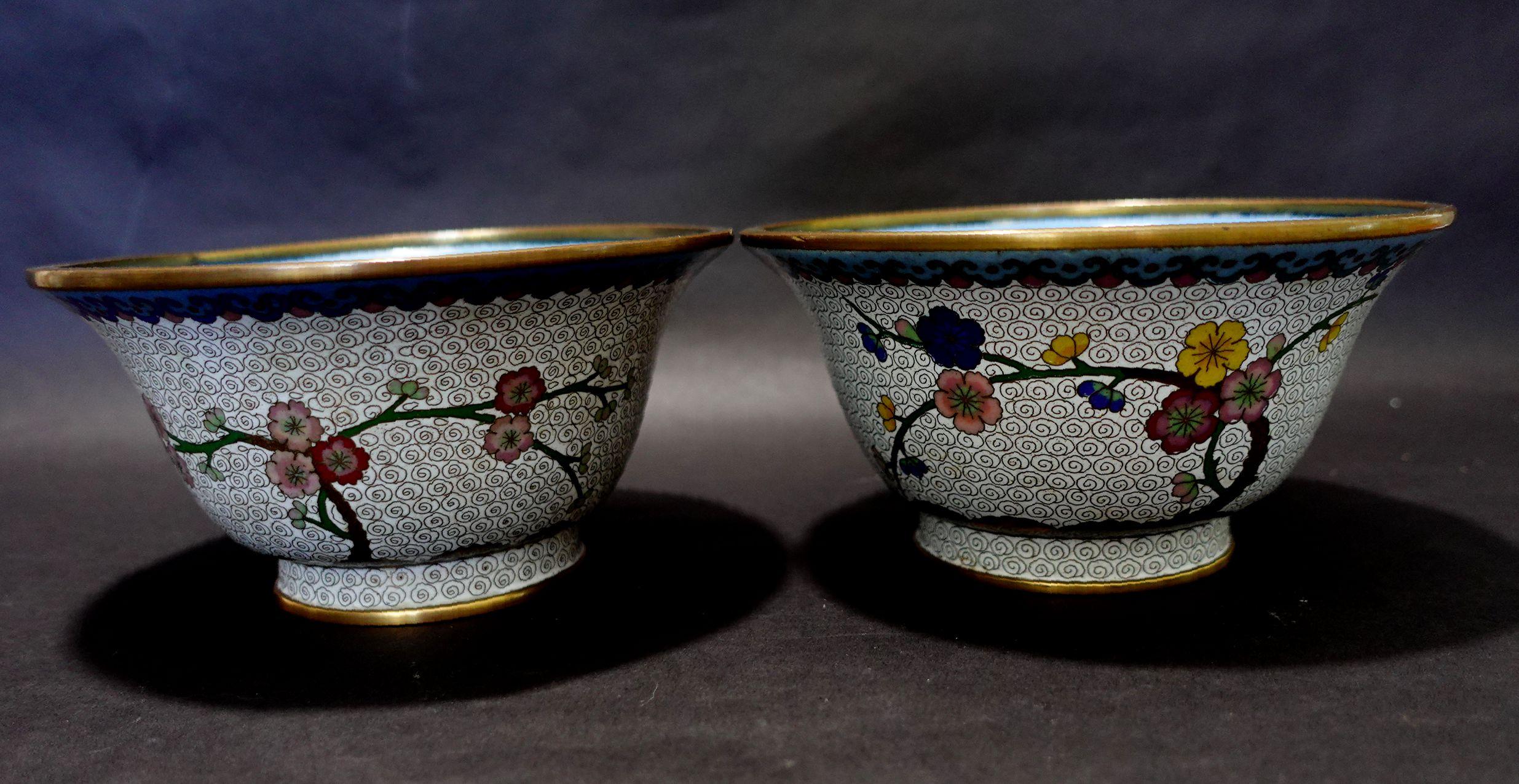 Antique pair of Thick and Heavy Chinese cloisonné enamel Bowls depicting floral patterns. A white base tone and colorful floral all around, from the 19th century.
