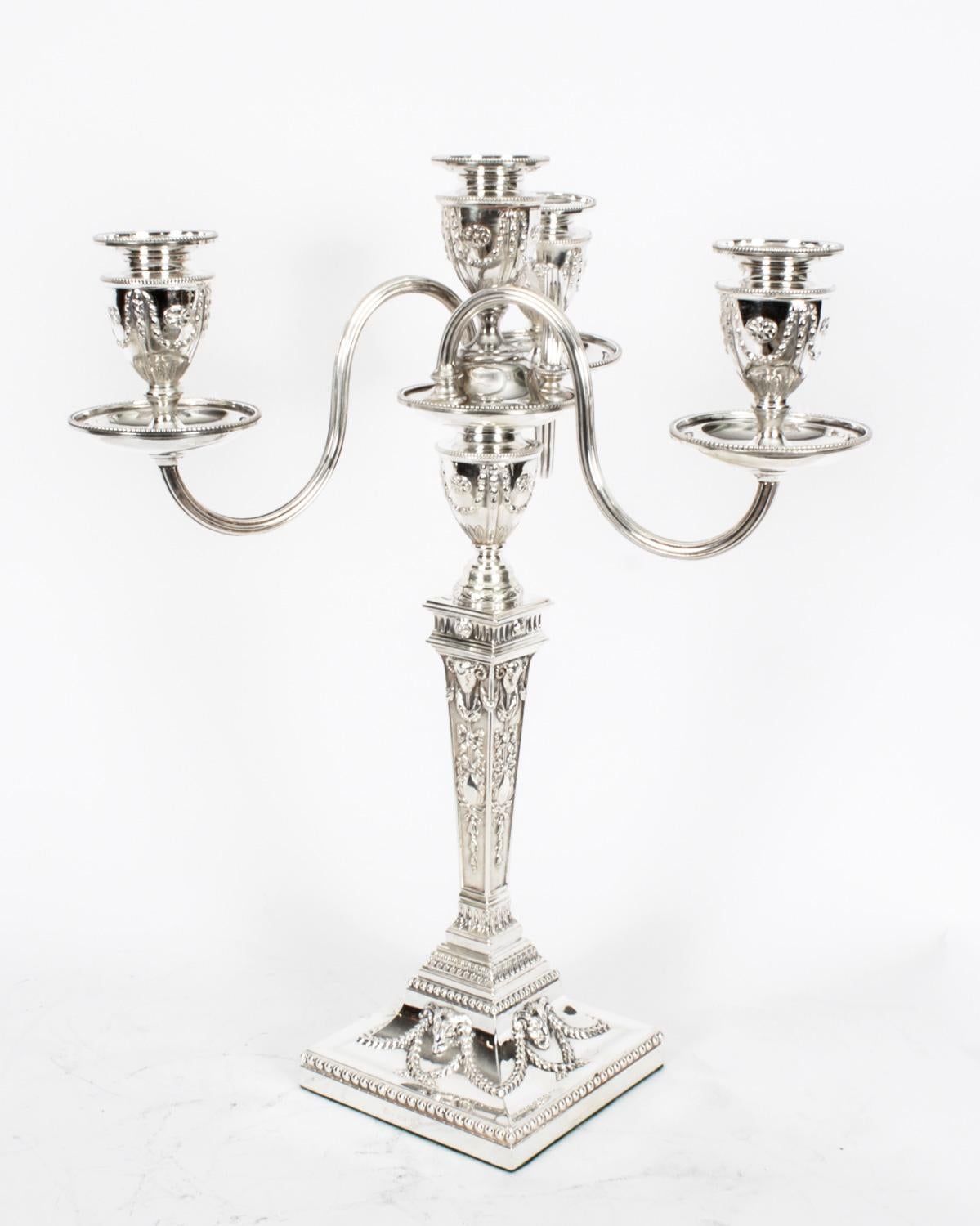 This is a stunning pair of English antique neo classical design Victorian silver plated, four light, three-branch table candelabra, circa 1865 in date, and each bearing the makers mark of the renowned English silversmiths Elkington & Co.

The