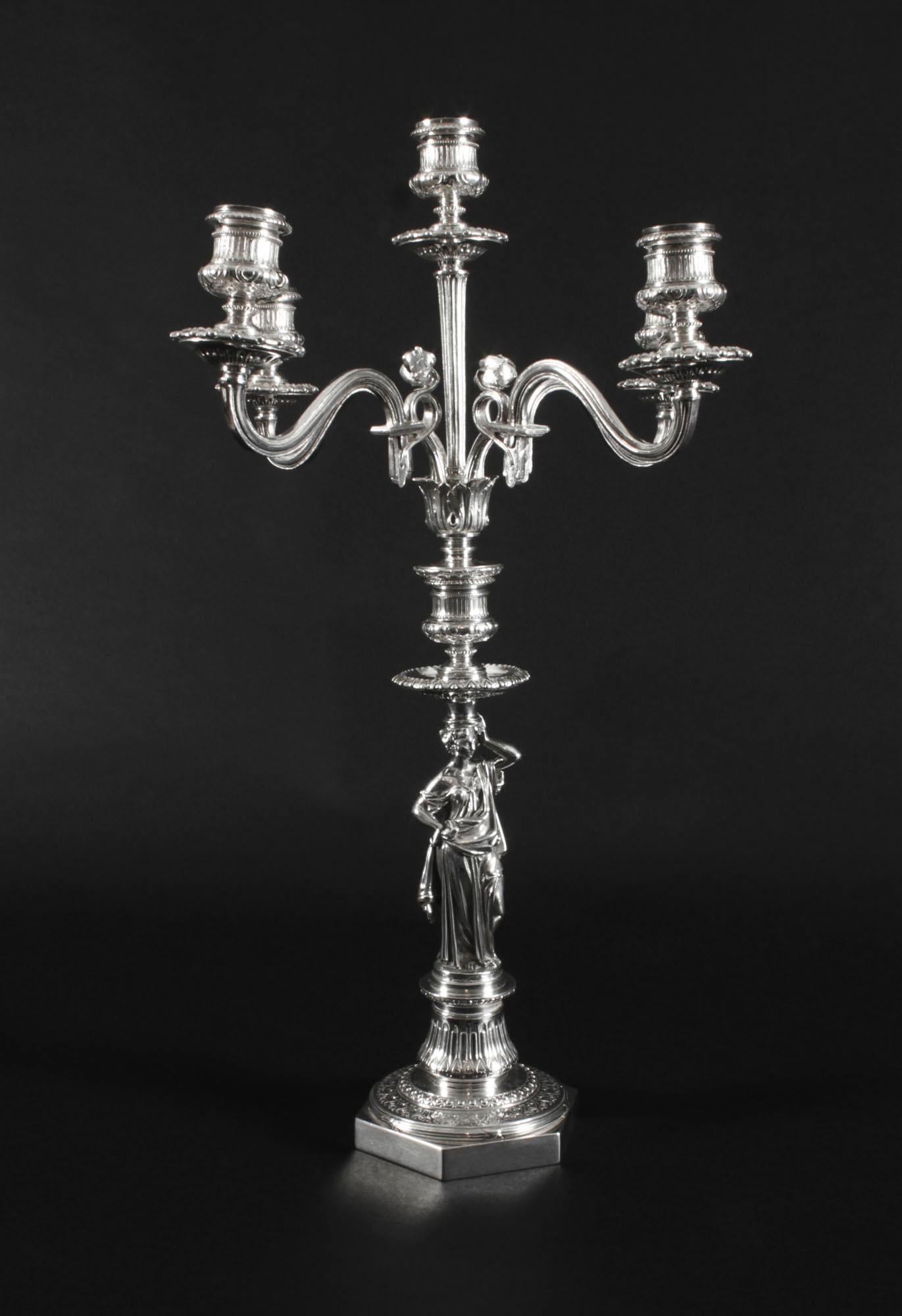 This is a stunning pair of English antique neoclassic design Victorian silver plated, five light, four-branch table candelabra, circa 1890 in date, and each bearing the makers mark of the renowned English silversmiths Elkington & Co.
 
The