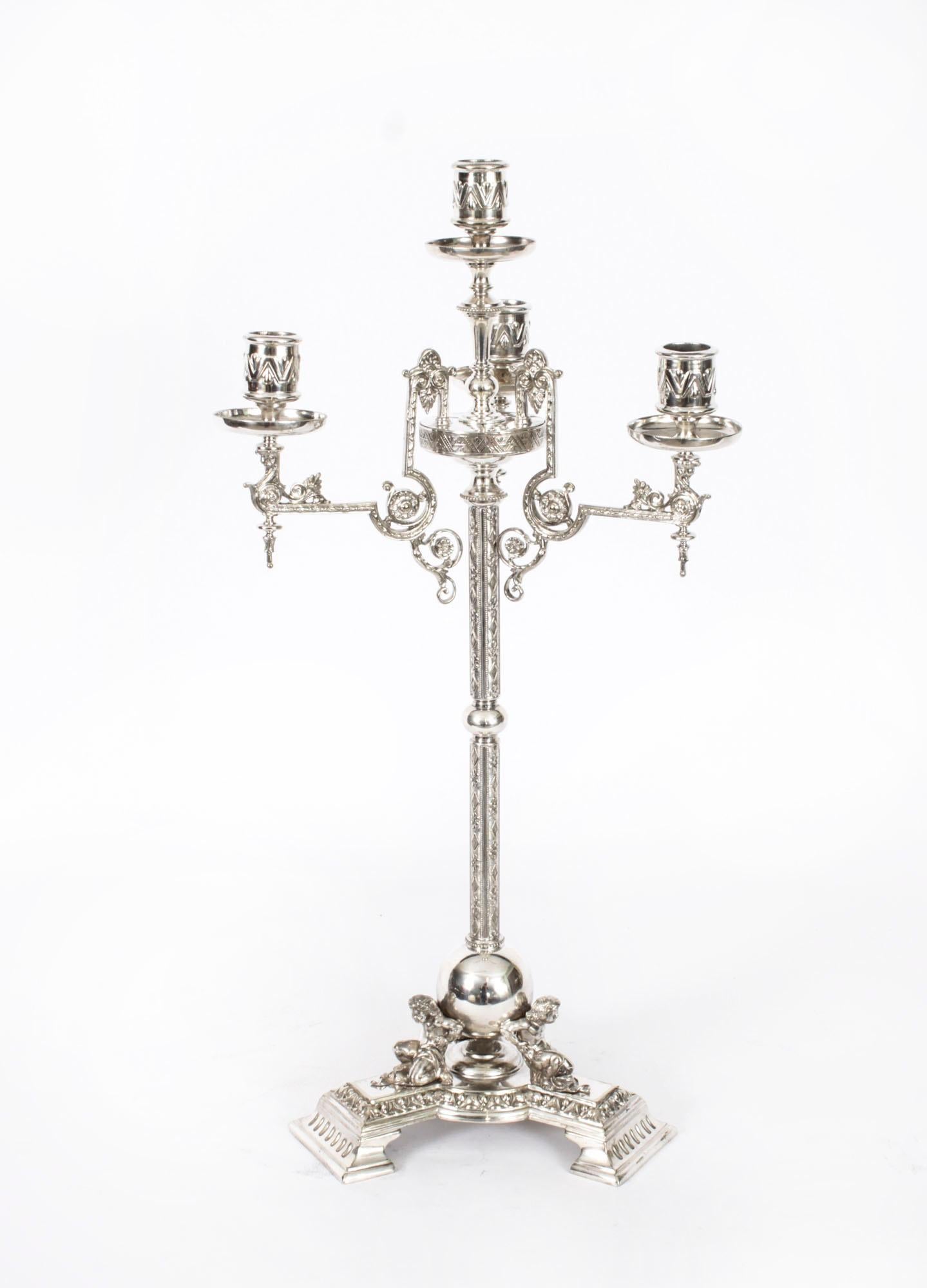 This is a stunning pair of English antique Neo Classical design Victorian silver plated, five light, four-branch table candelabra, circa 1880 in date, and each bearing the makers mark of the renowned English silversmiths James Dixon and  sons.

The