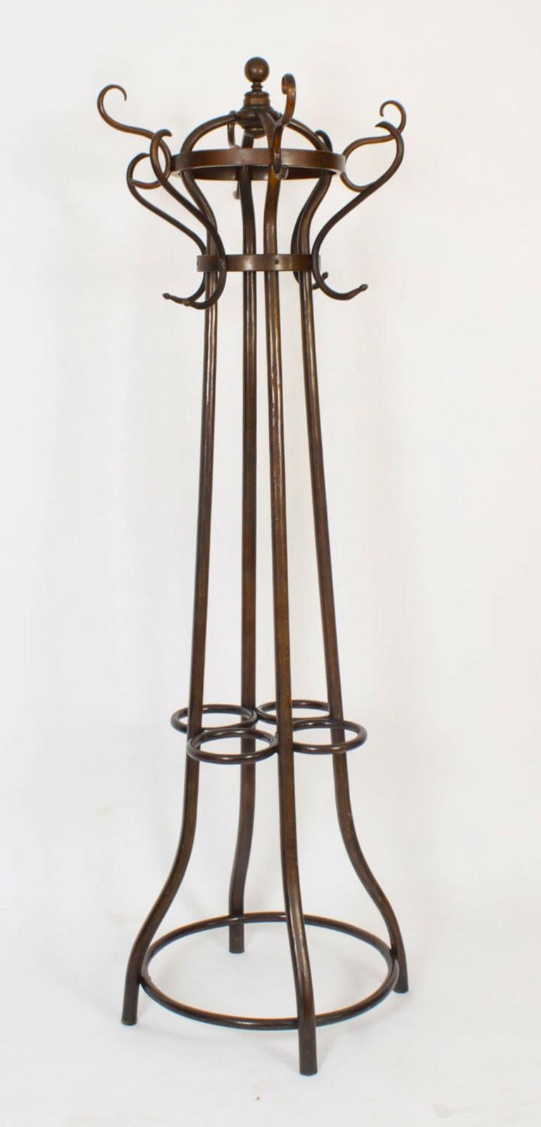 An excellent and rare antique pair of Thonet Vienna Art Nouvean free standing ormolu mounted bentwood coat / hat / stick stands, late 19th century in date.
The pair of  stained beech bentwood hall stands feaure eight S-scroll form hat and coat pegs