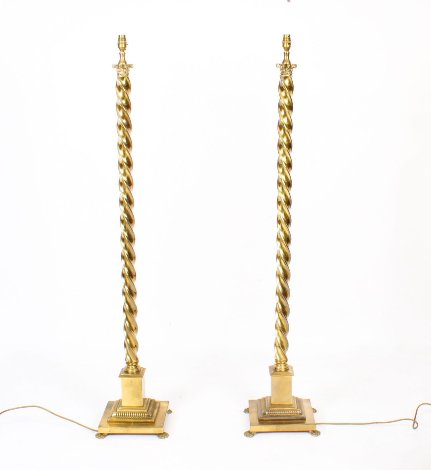 This is a beautiful antique pair of Victorian brass floor standard lamps now converted to electricity, circa 1890 in date.

The splendid lamps feature distinguished twisted cylindrical columns topped with Corinthian capitals. 

They stand on