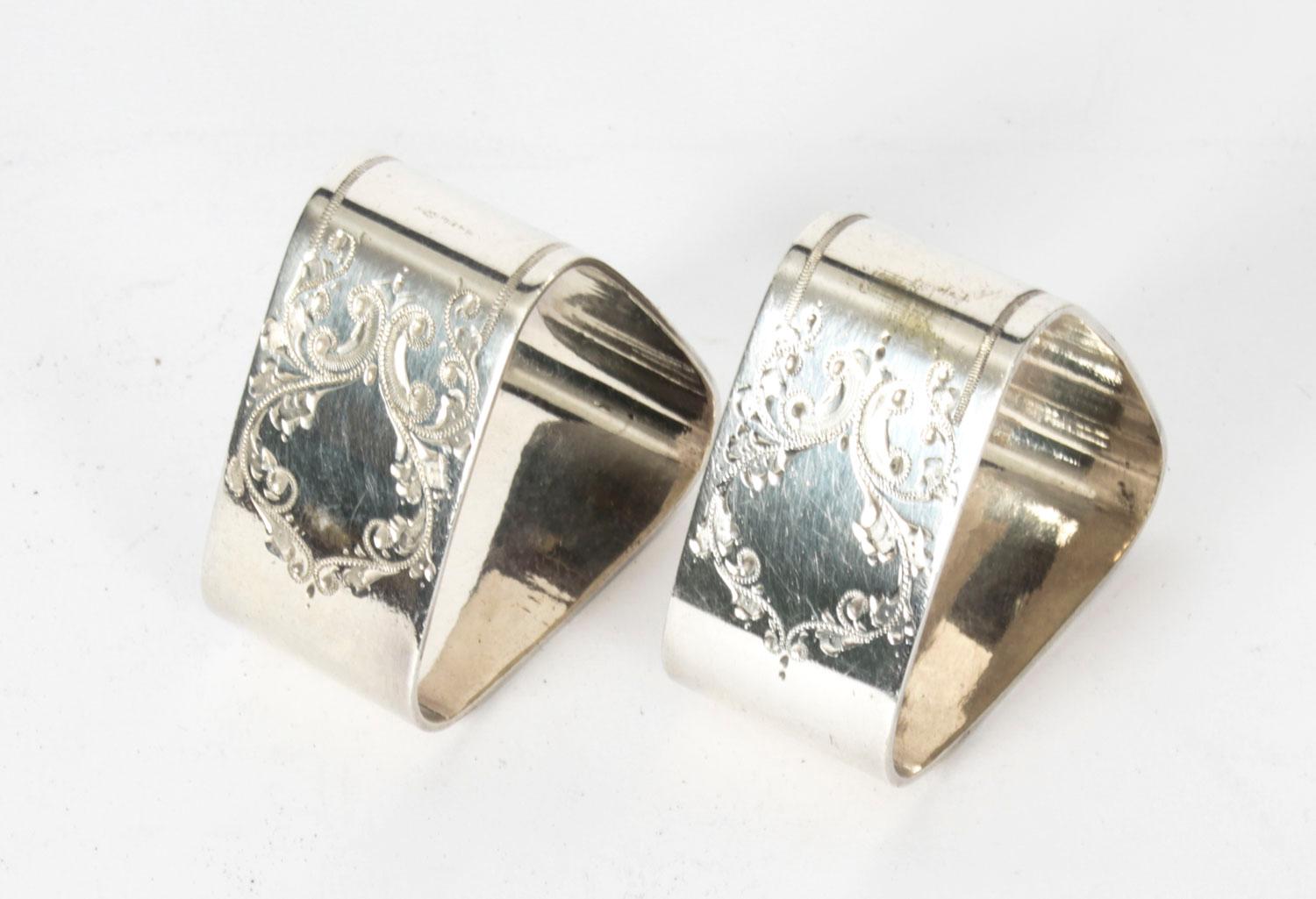 A lovely pair of antique Victorian silver-plated napkin rings circa 1880 in date.
 
The triangular shaped ring feature machine engraved fancy floral pattern and come in their original leather fitted case with purple silk interior.
 
The