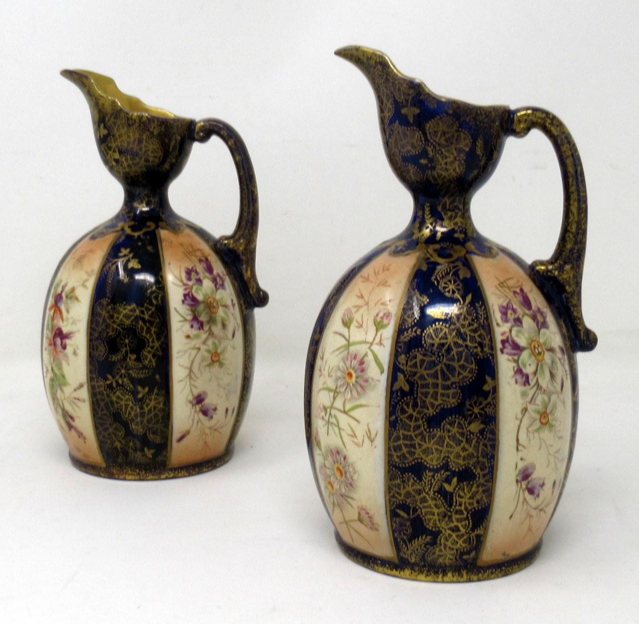 An unusual Pair of English Victorian Phoenix Ware Hand decorated porcelain Ewers made in Staffordshire, England by Thomas Forester & Sons with date mark used for period 1891-1912 

Each of ovoid outline with applied C scroll handle and gilded