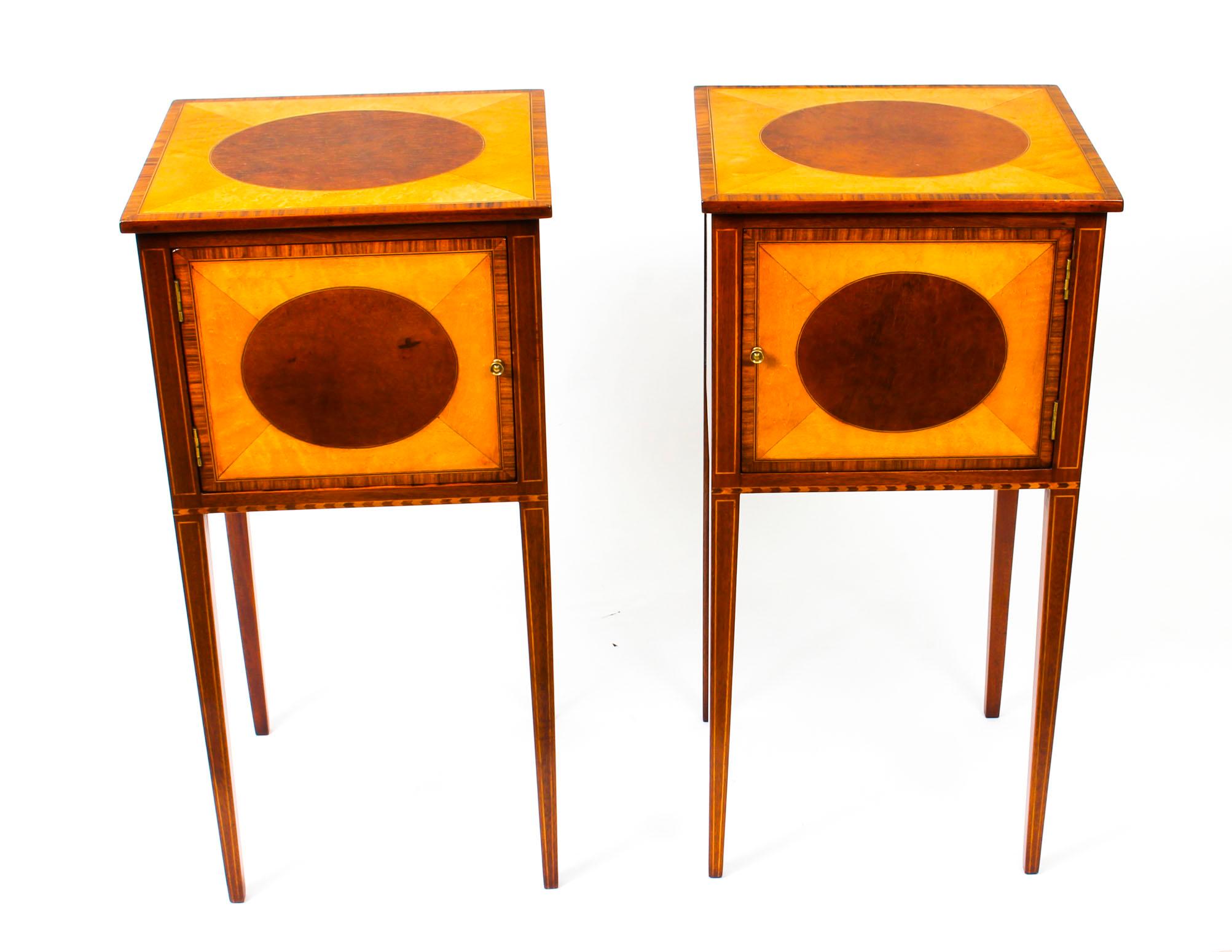 A lovely pair of antique Victorian Sheraton design mahogany and sycamore bedside cabinets circa 1880 in date.

The rectangular tops feature inlaid oval frames in sycamore, crossbanded in tulip wood, above a single door. They are raised on square