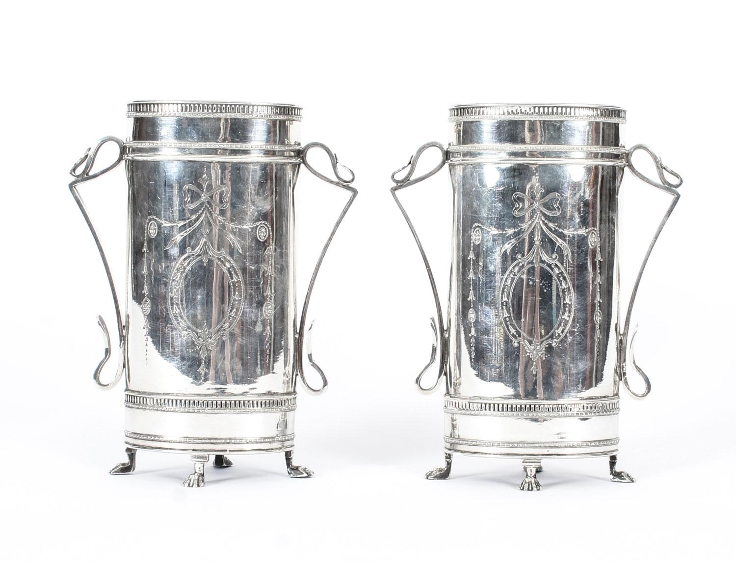 This is a beautiful pair of antique Victorian neoclassical silver plated vases, bearing the silversmith's makers' mark AW & JH, circa 1880 in date.
 
The oval vases features elegant engraved ribbon decorations to the body with pierced rims, finely