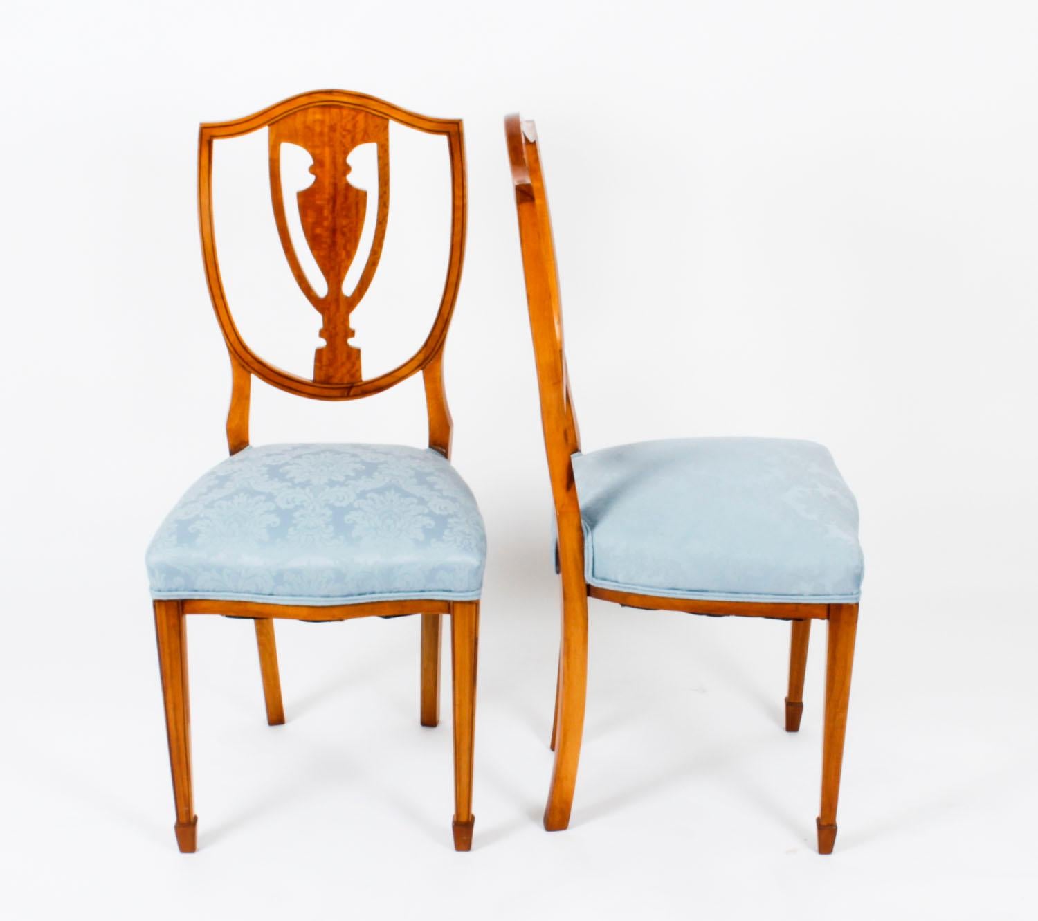 This is a lovely pair of antique Victorian shield back satinwood chairs, circa 1880 in date.
 
The stunning chairs feature sumptuous and highly attractive shield backs with a pierced back in the form of a classical vase and twin ebonized line
