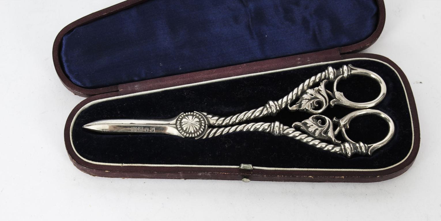 This is a very lovely pair of antique Victorian silver plated grape scissors , bearing the makers mark of Hartley Baxter & Co., and circa 1880 in date.
 
They feature a gadrooned decoration to the arms with acanthes handles.

Add an elegant