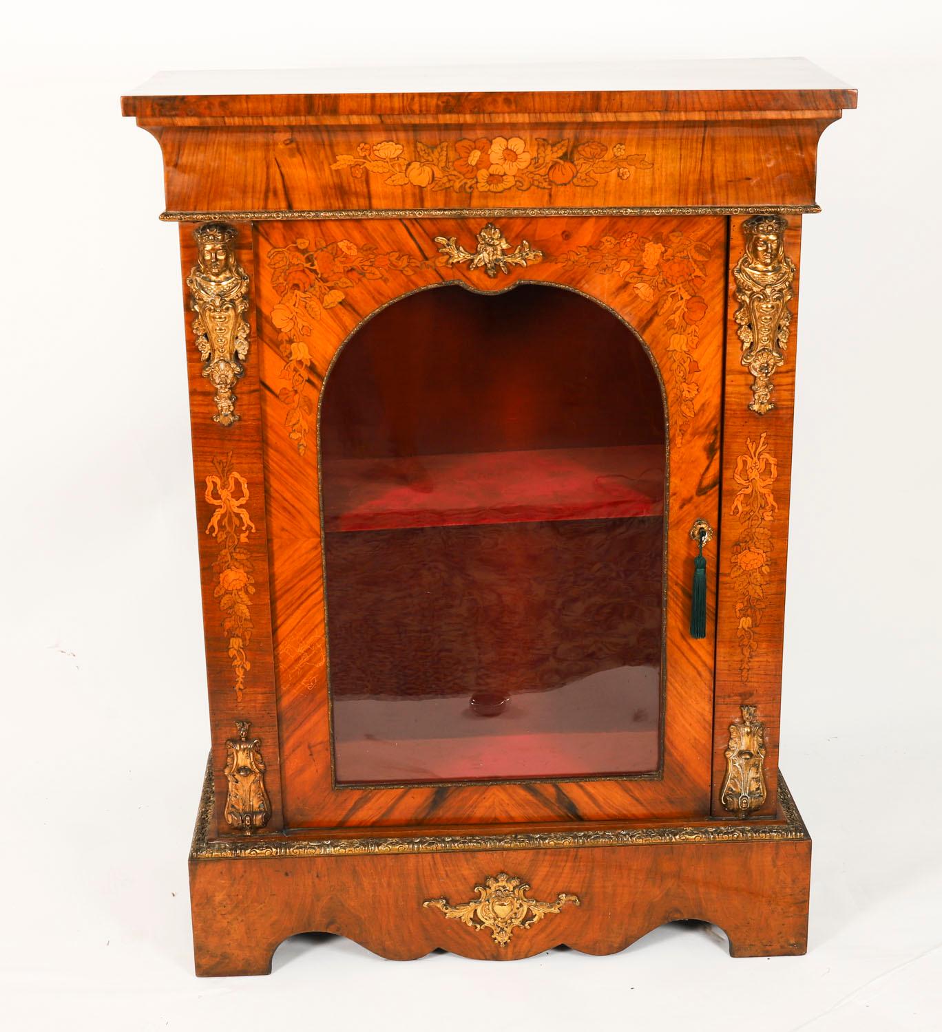 This is a superb antique pair of decorative Victorian burr walnut and floral marquetry pier cabinets, dating from Circa 1860.

Adding to their truly unique character they are  decorated with exquisite gilded ormolu mounts and further embellished by