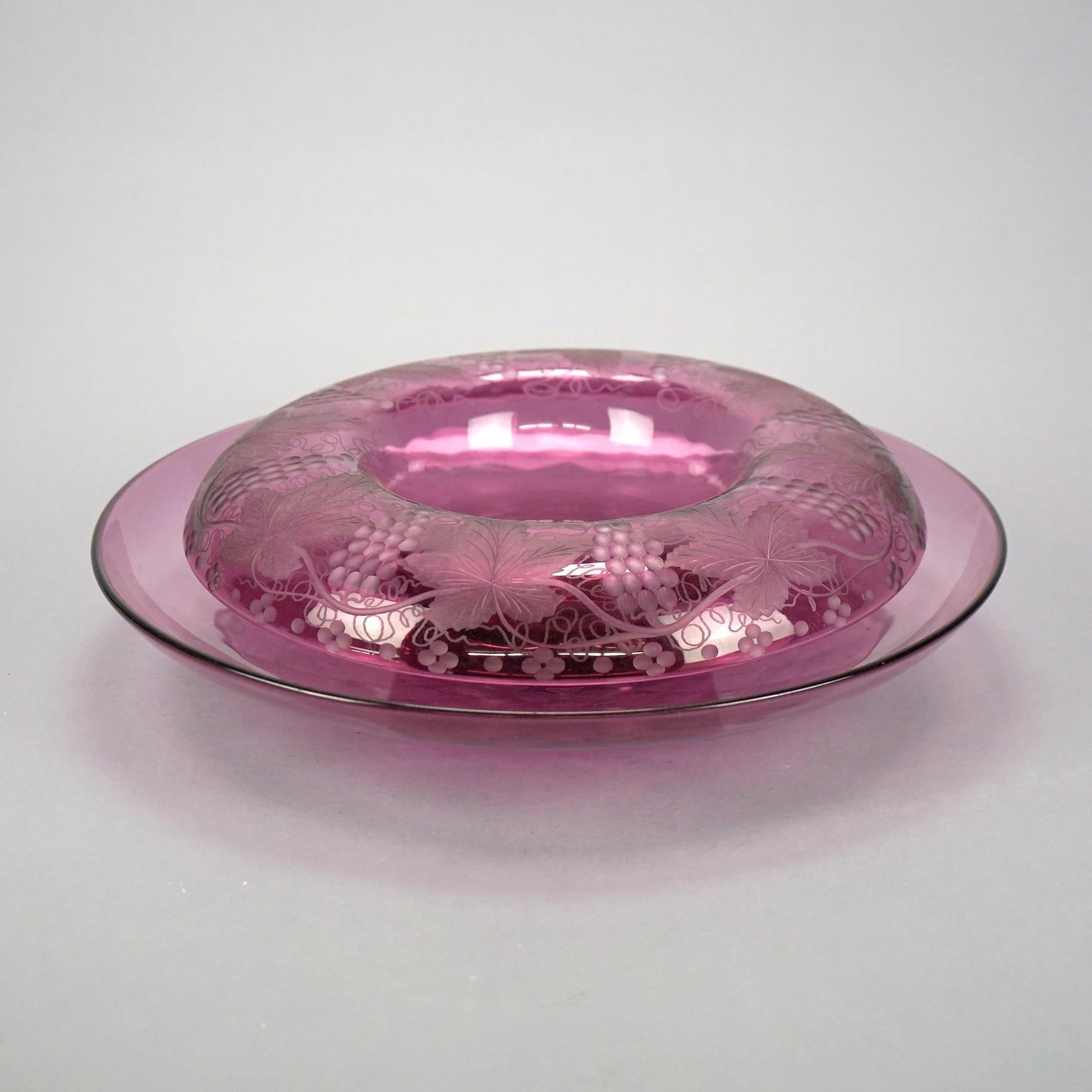 An antique Pairpoint Elegant glass center bowl and liner offers etched grape and leaf design, c1920

Measures- underplate 2.5'' H x 16.5'' W x 16.5'' D; bowl 3.5'' H x 13.5'' W x 13.5'' D.