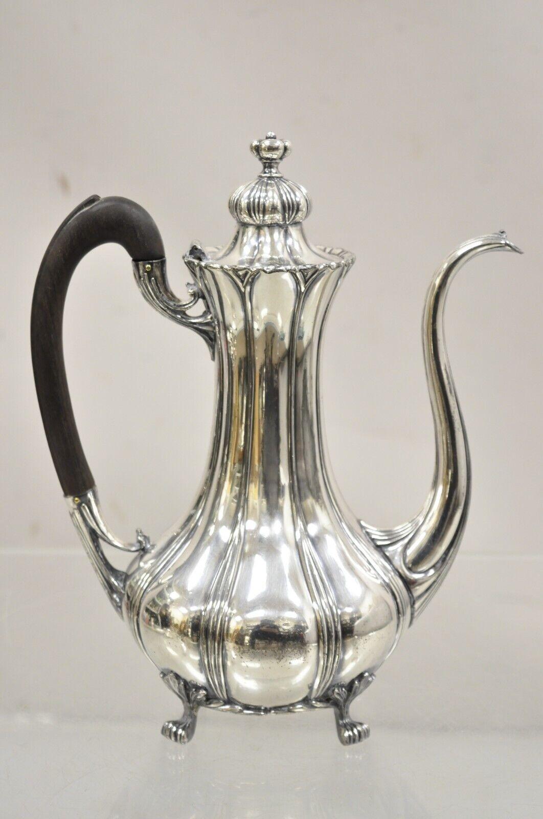 Antique Pairpoint Mfg. Victorian Silver Plated Tea Pot Coffee Pot. Item features a wooden handle, original hallmark, footed base. Circa Early 20th Century. Measurements: 10
