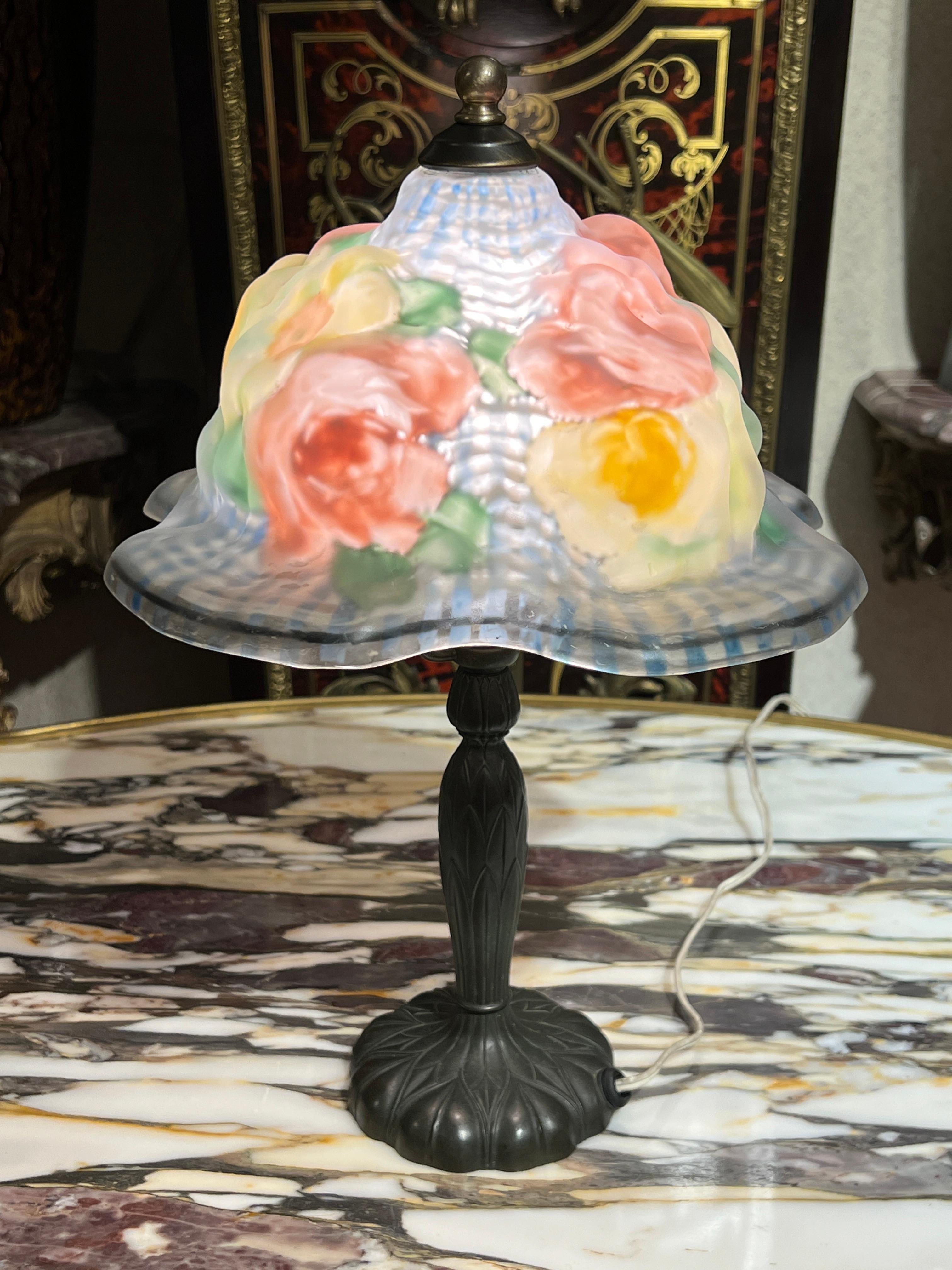 Lovely table lamp from Pairpoint with reverse painted peony flowers in various colors.  13 by 9 inches.  Glass signed with the stamped mark of the maker on  the interior edge of the shade.