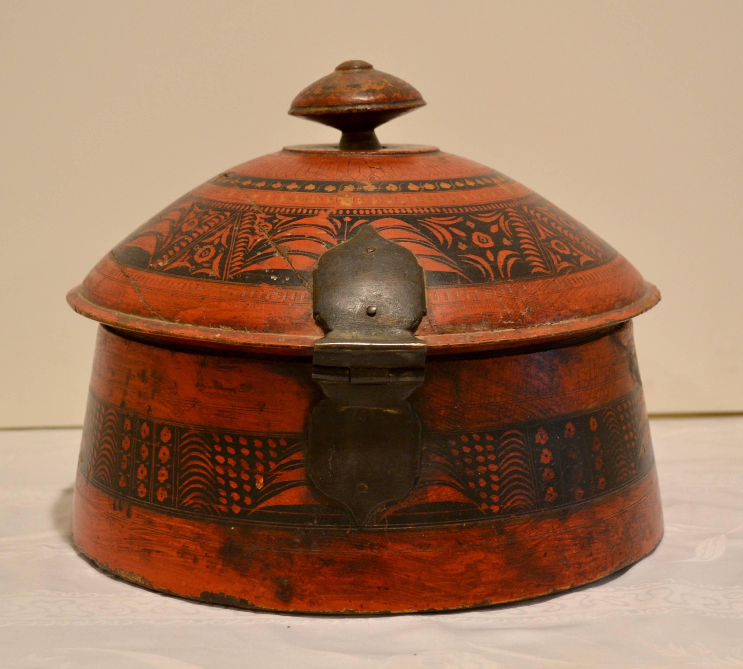 This is an outstanding antique hand-turned wooden spice box from Pakistan, with beautifully incised and hand-painted floral and leaf decoration in red and black. One of the largest examples we have seen, the bold domed lid opens on an iron hinge to