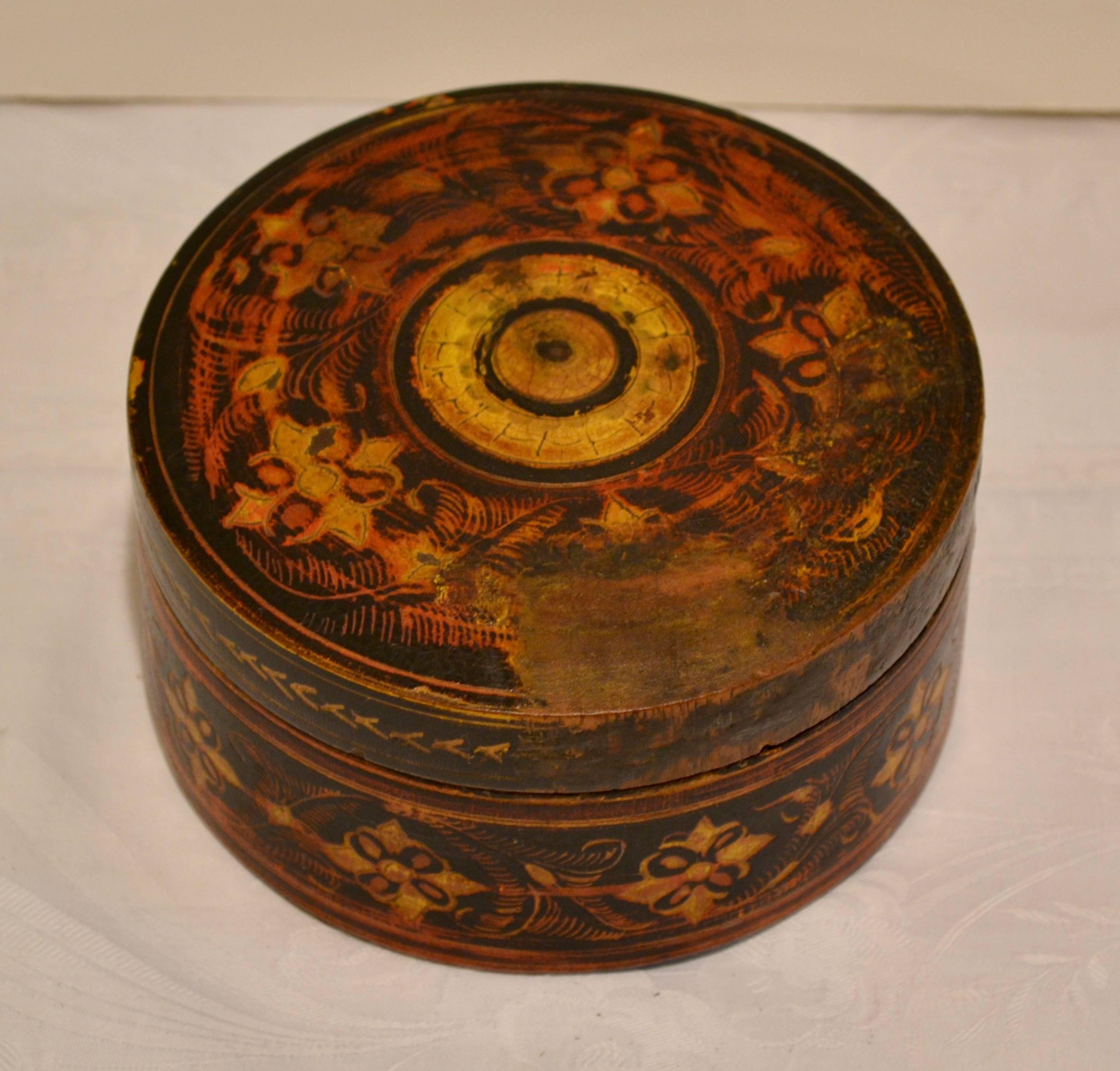 This is a handsome hand-turned antique tribal spice box from Pakistan, with a complex hand-painted and incised decoration in black, red, and gold. The box itself is in superb condition with a complete rim and well-fitting top. Chips in the paintwork