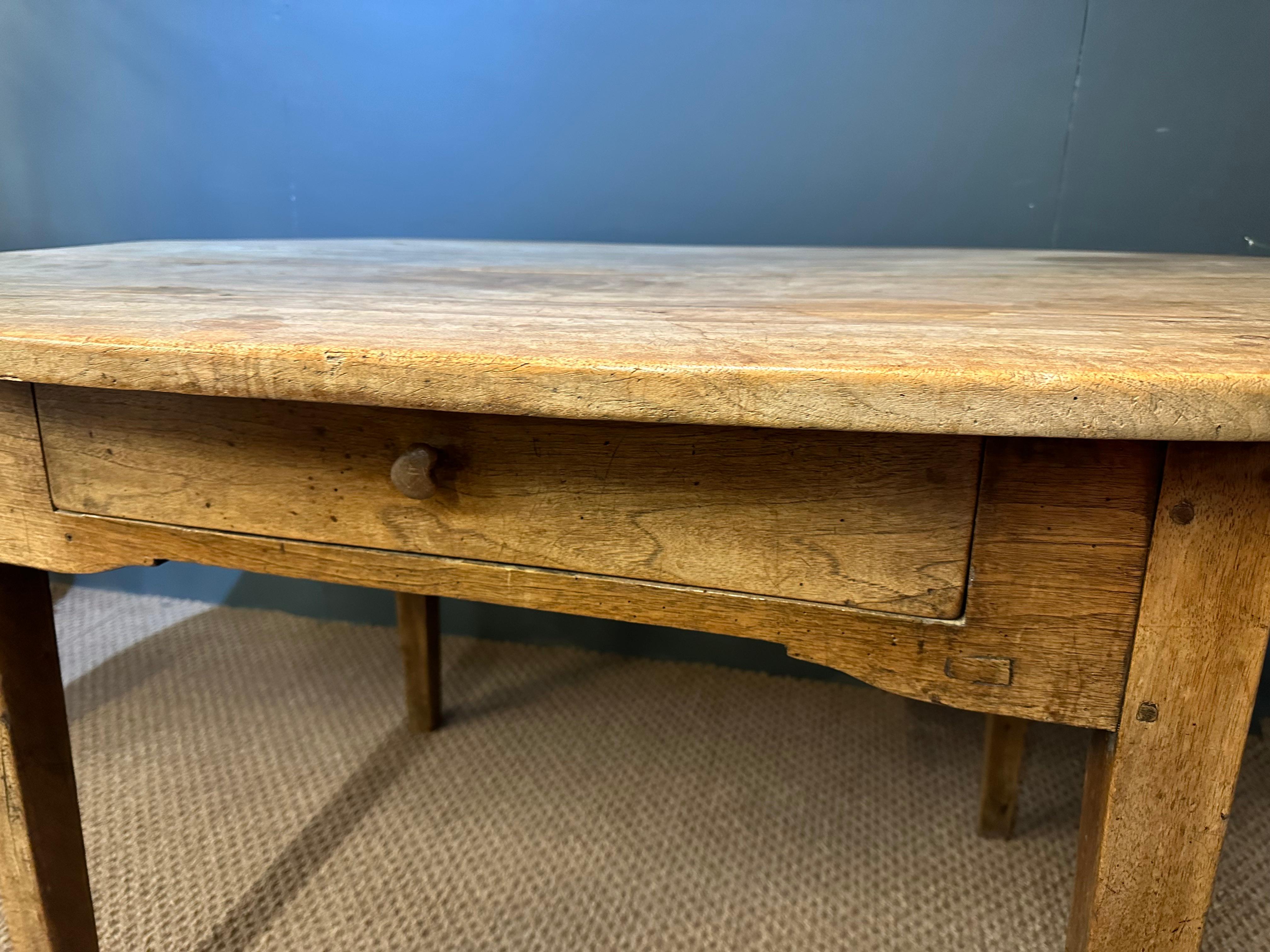 This very Pale Antique Oval-ended walnut table is very rare, the table stands on a lovely pale walnut apron with beautifully tapered legs and has one large drawer with dividers. The top is worn pale rustic four plank. This table is a very