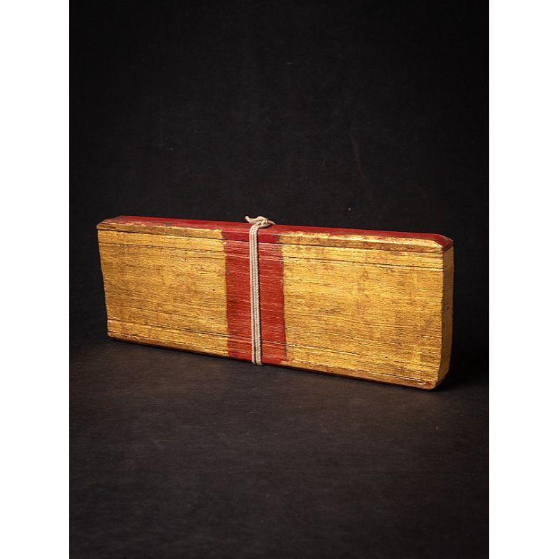 Material: Palm leaves & wood
Material: wood
15,9 cm high 
43,2 cm wide and 4,5 cm deep
Weight: 1.260 kgs
Gilded with 24 krt. gold
Originating from Burma
19th century
Many pages, made of Palm leaves covered with 2 wooden covers.
Is also