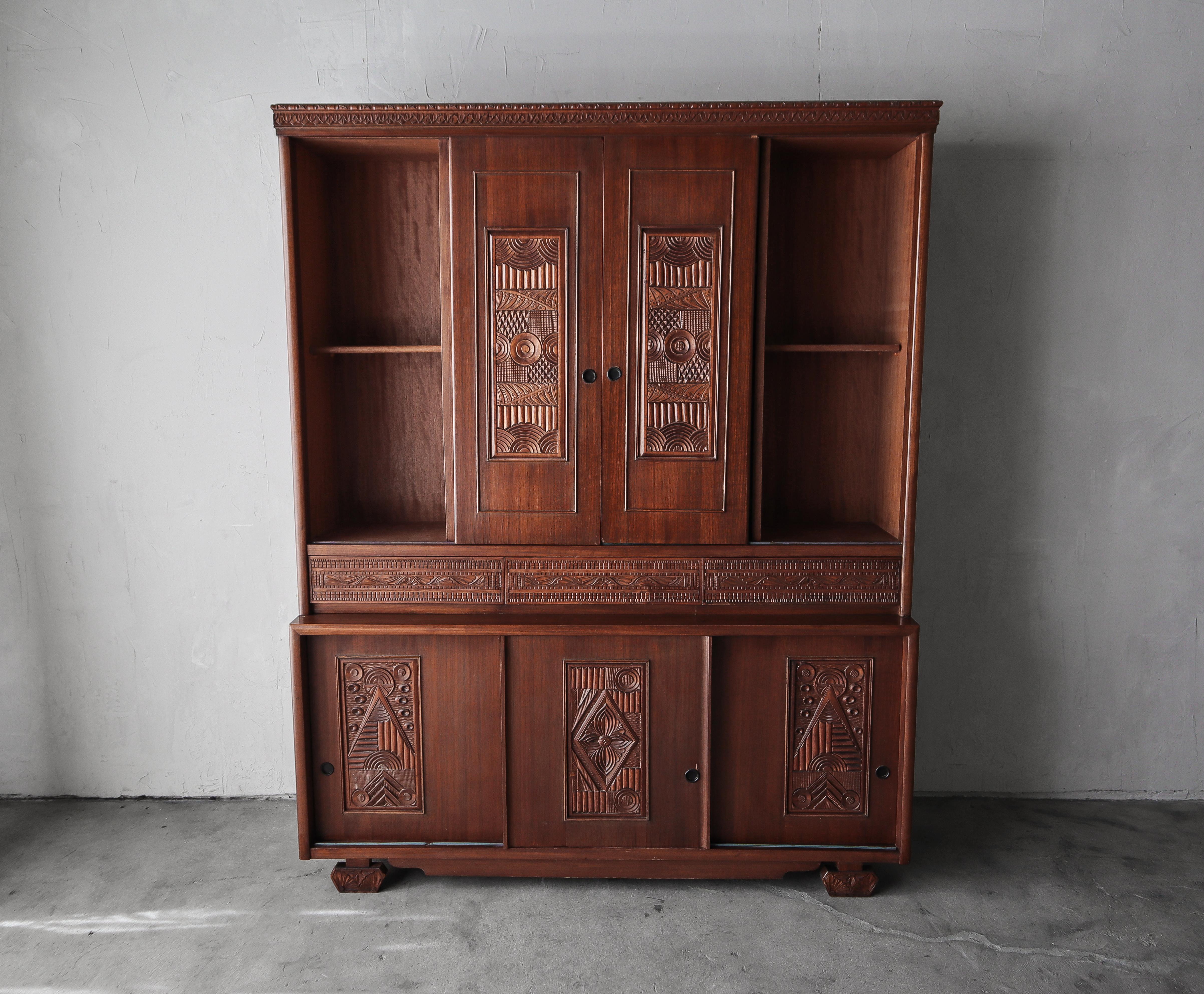 This antique, carved wood cabinet is truly unique.  So unique I have been unable to find another example of any kind.  Everything from the legs and trim, to the doors and drawer fronts are carved in the most unique, intricate and gorgeous manner.  A