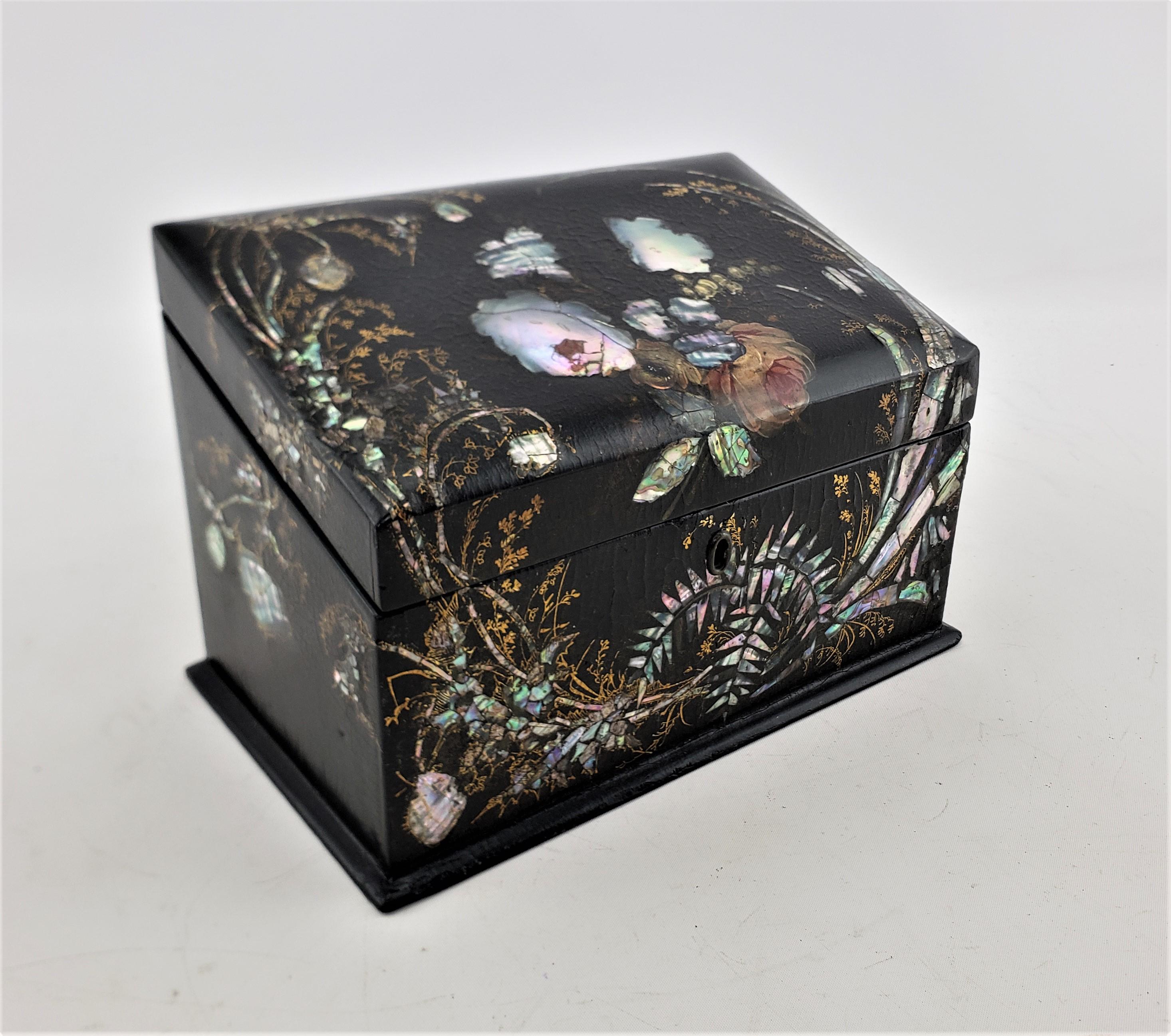 This antique trinket or jewelry box is unsigned, but presumed to have originated from England and date to approximately 1880 and done in the period Victorian style. The box is composed of paper mache which has been treated in black laquer with