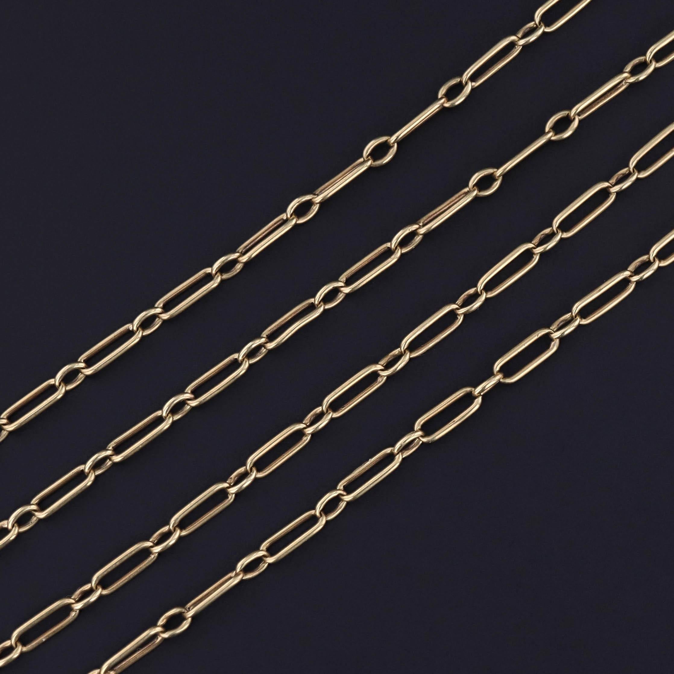 An antique watch chain of 14k gold paperclip links with a spring clasp at the bottom for holding charms, a watch, or a pendant.

The lariat style necklace measures 32 inches with a 2 inch drop and weighs 7.25 grams. It is in great condition.

The