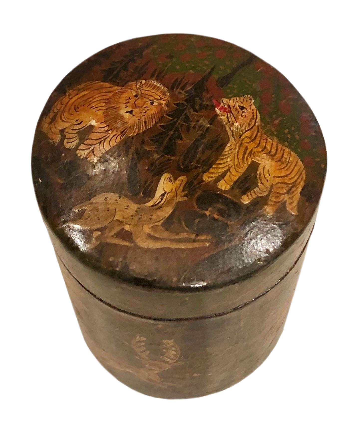 An attractive 1920s papier mâché cylinder box hand painted with animals, lions, tigers, deer or antelope. Very beautifully painted and whimsical The bottom has an old paper label on it could be the company. From Kashmir, India.