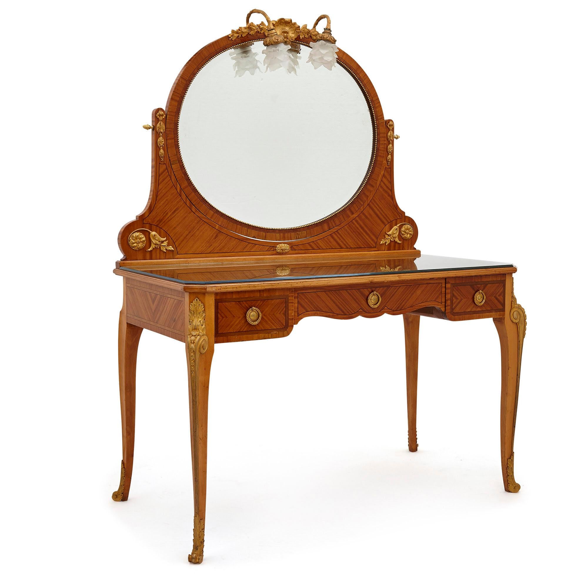 Antique Parisian neoclassical style dressing table set by Au Gros Chêne,
French, late 19th century
Dressing table: Height 167cm, width 124cm, depth 65cm
Chair: Height 95cm, width 44cm, depth 42cm

This elegant dressing table and chair set is