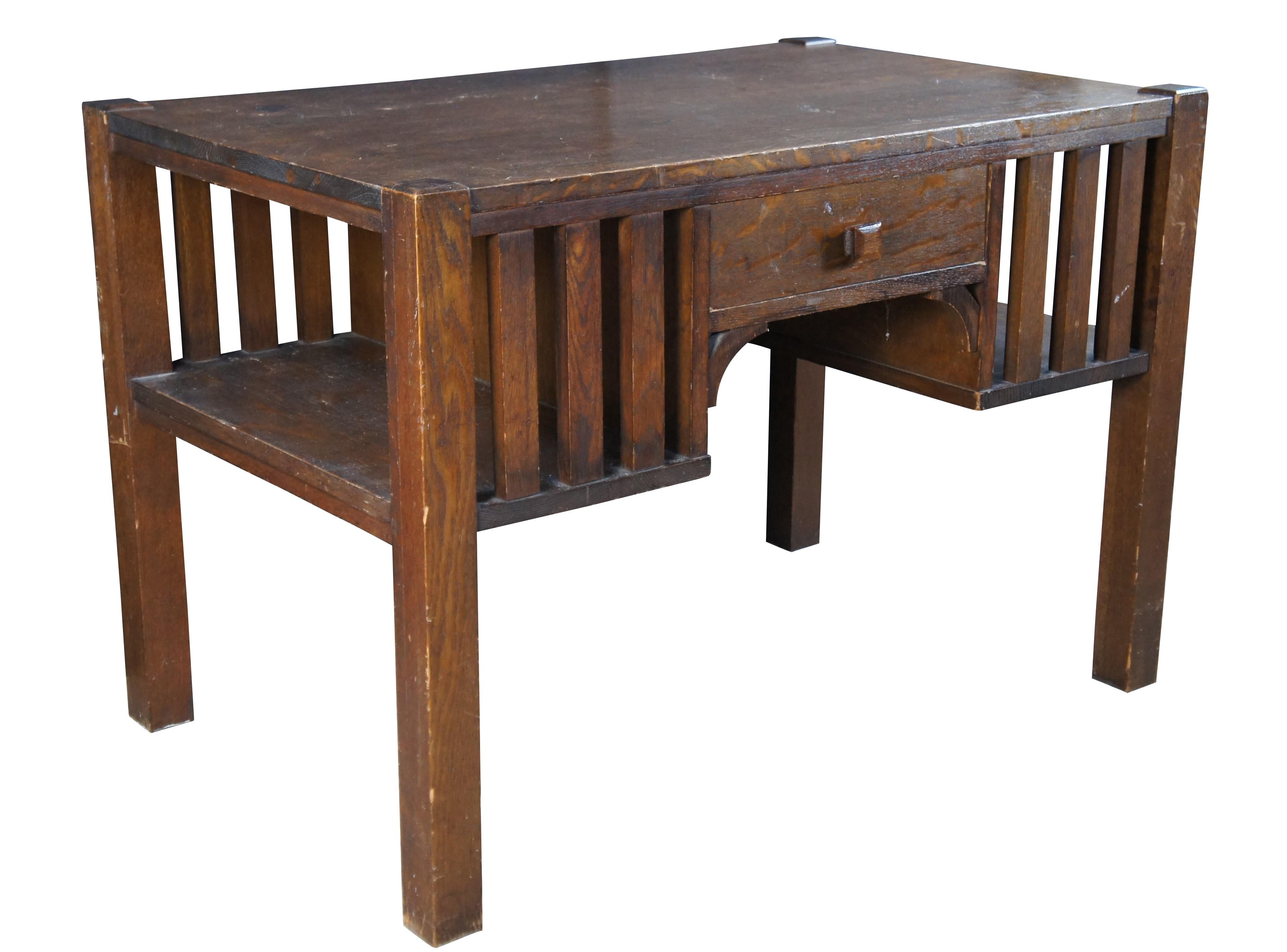 Antique quartersawn oak library table or desk by The Park Furniture Company of Rushville Indiana.  The desk features Mission and Arts and Crafts styling with bookcase or bookshelves flanking a kneehole with a single drawer.

Dimensions:
29