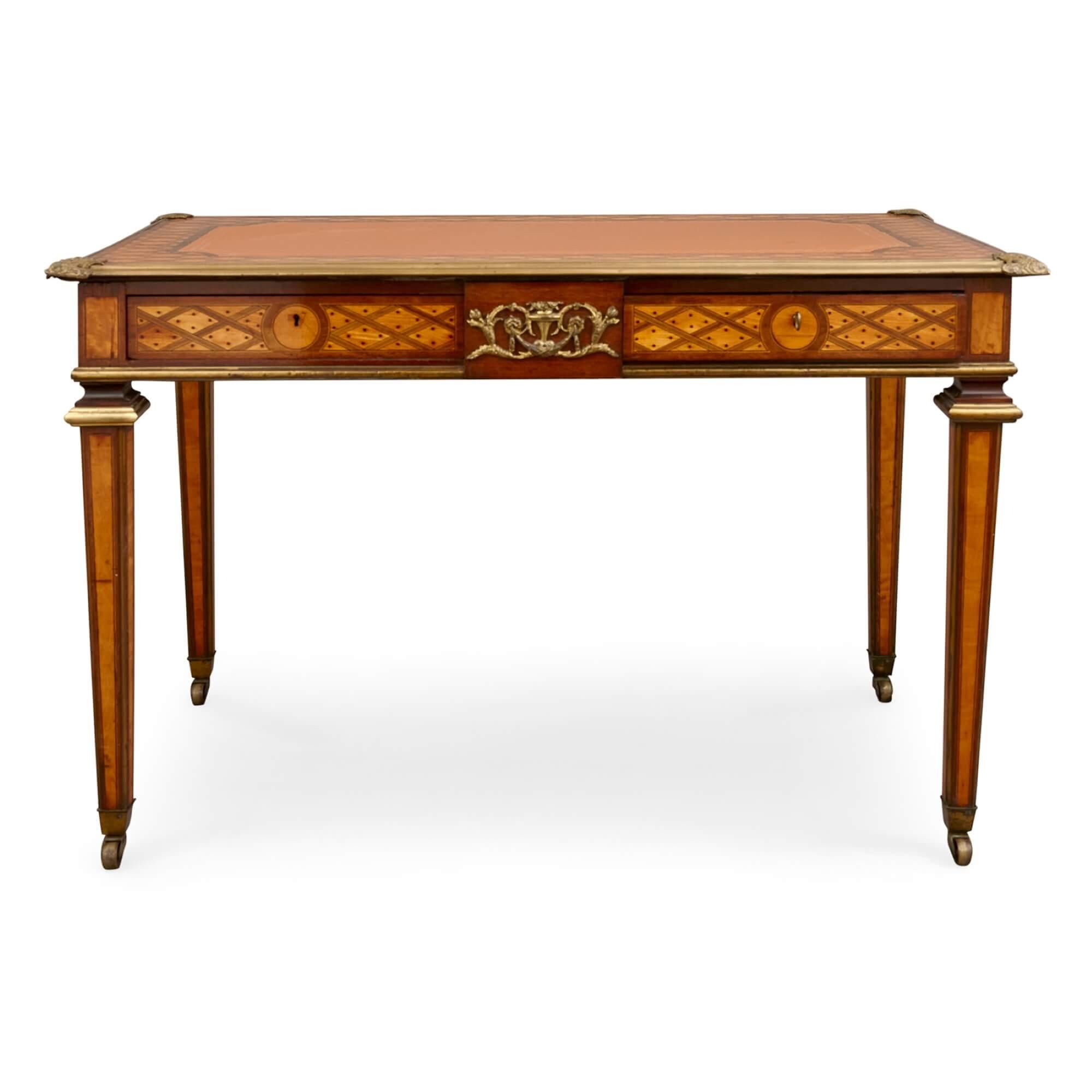 Antique parquetry, ormolu and leather bureau plat by Ross 
English, 19th Century
Height 76cm, width 120cm, depth 69cm

Made by the renowned English furniture maker Donald Ross, this desk is a demonstration of some of his finest work. 

The