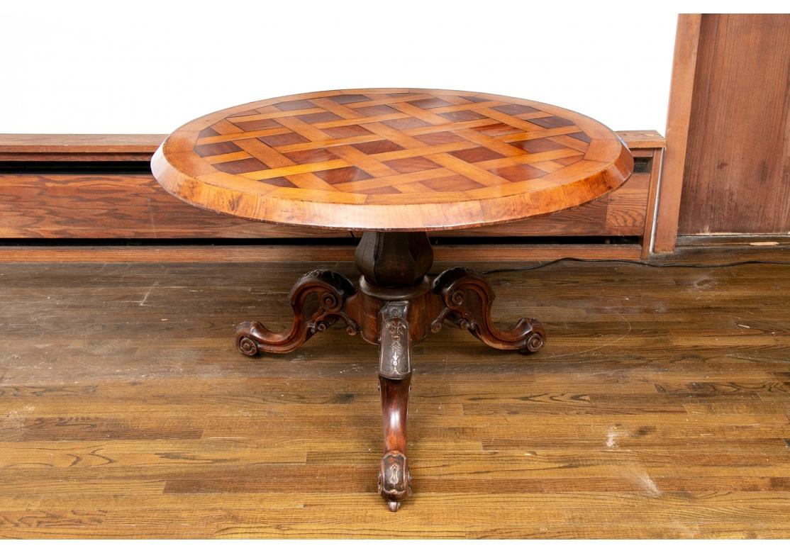 Un tavolo in parquet bello e insolito da utilizzare come tavolo da centro o da pranzo.  Il piano a fasce è in parquet con motivo a reticolo e fasce larghe. È rimovibile (mancano le viti). Sollevato su un supporto scuro sfaccettato montato su una