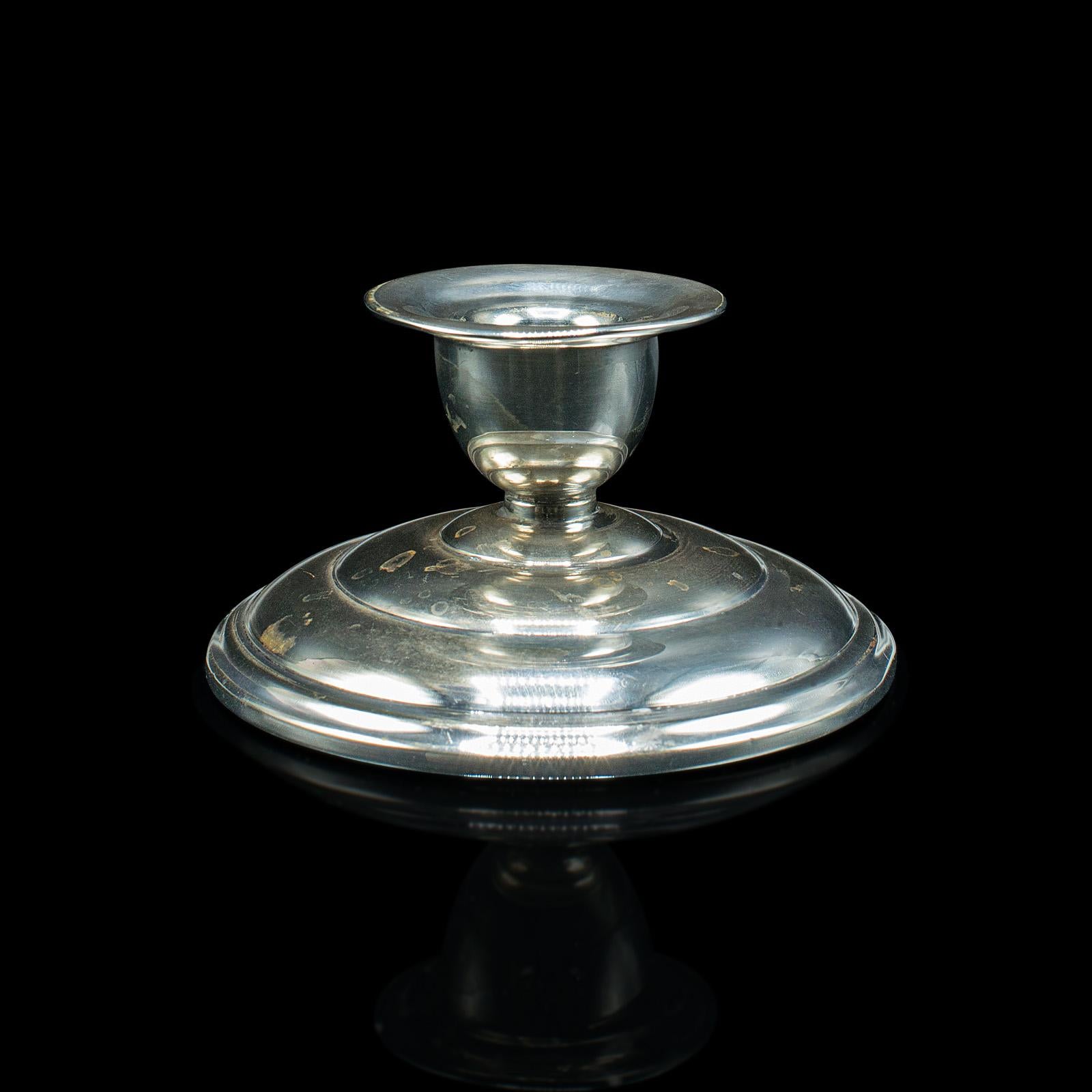This is an antique parson's candle holder. An English, silver plate nozzle or ink well, dating to the late Victorian period, circa 1900.

Petite candle holder or desktop ink well with bright finish
Displays a desirable aged patina, with some minor