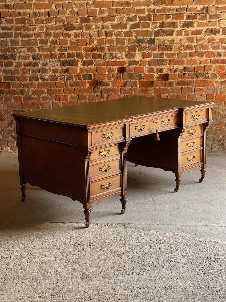 Antique partners desk oak 19th century Victorian, circa 1850

Stunning 19th century solid oak breakfront twin pedestal partners desk circa 1850, the deep rectangular top with a sumptuous olive green and gilt skived and tooled leather inset over