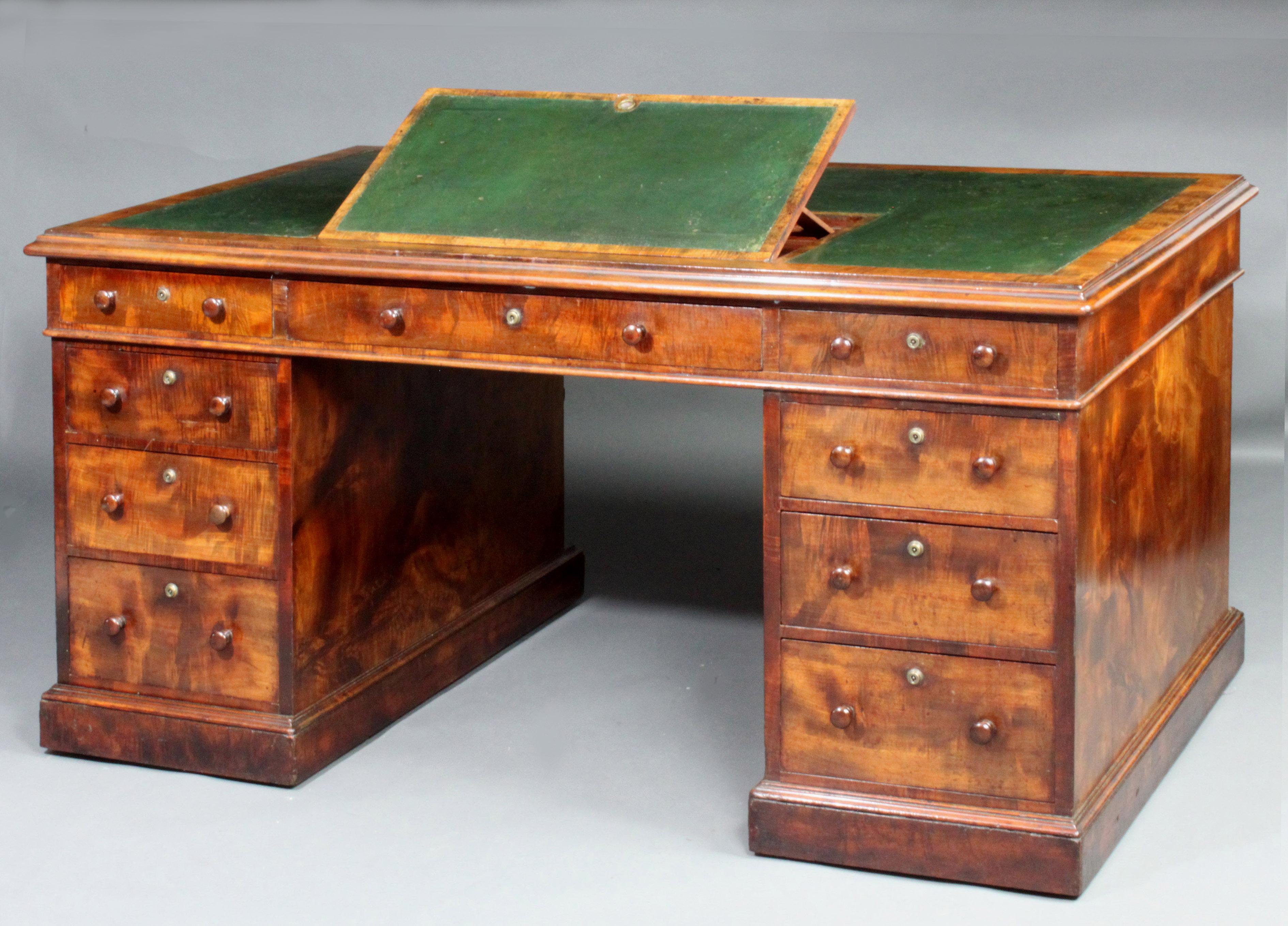 A fine quality partners desk in exceptional figured mahogany veneers, original dark green leather, bramah locks, ratchetted writing slope and mahogany lined drawers
Provenance: from Seend House, Wiltshire, England.