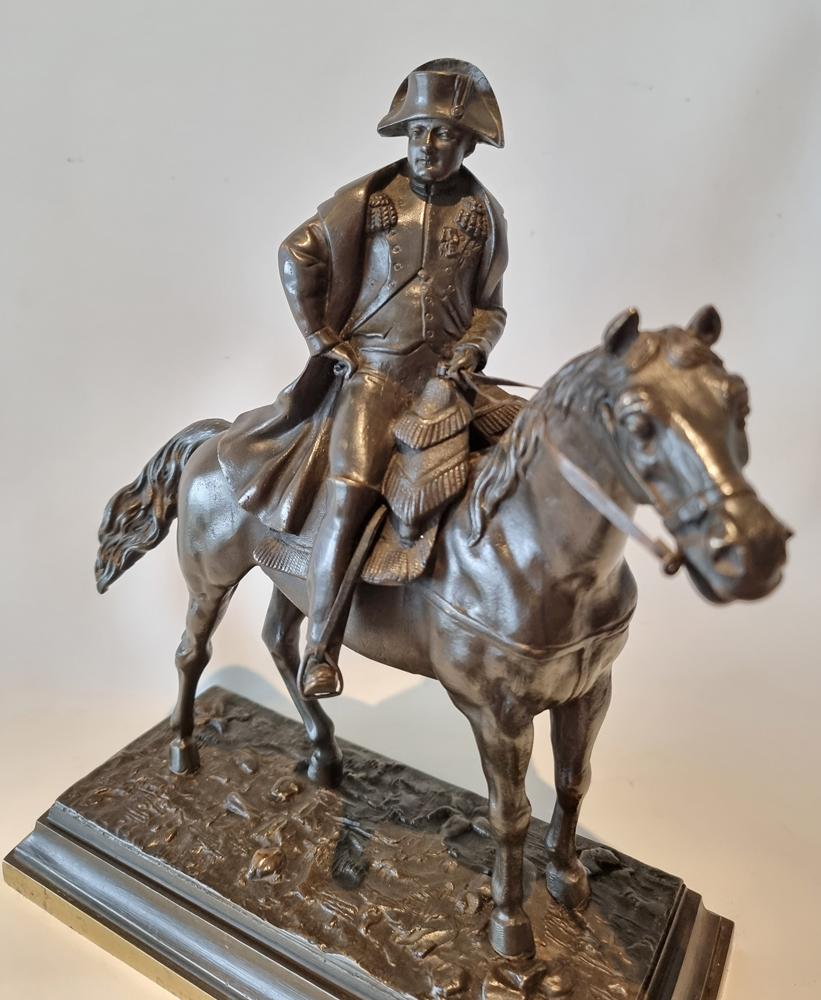 Fine patinated bronze of Napoleon Bonaparte in full uniform set on his horse, upon a a gilt bronze base. Superb quality in the horse and Napoleon.