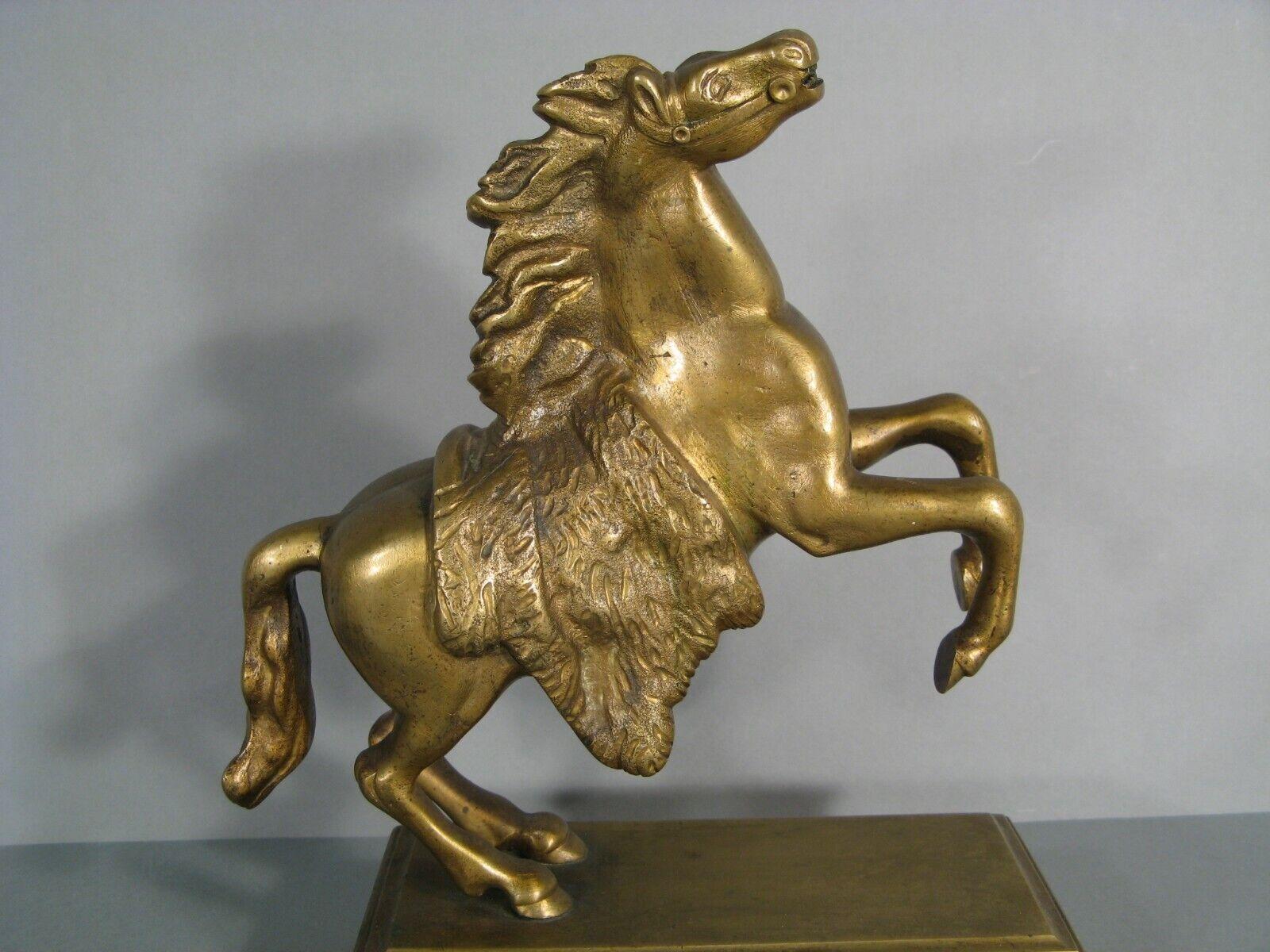 A finely crafted antique sculpture in patinated bronze, depicting a rearing horse.

Material: Patinated Bronze
Design: Rearing Horse
Era: Late 19th Century / Early 20th Century
Condition: Light wear to the patina from usage; needs cleaning.
Notes:
