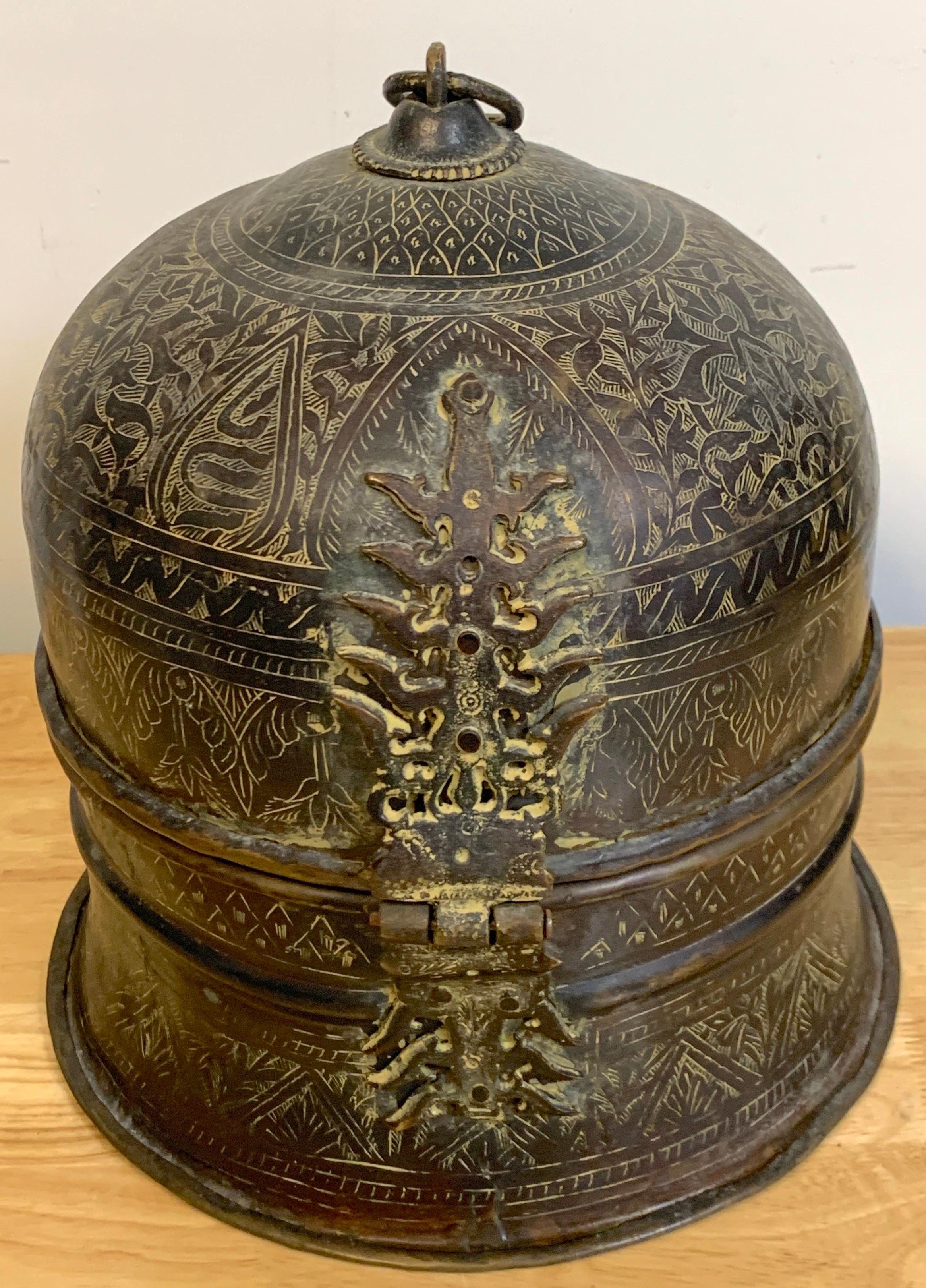 Antique Patinated & Engraved Bronze Mughal Domed Box
India, 20th century 

A fabulous Indo-Islamic architectural circular domed box, with elaborate front hinge, all over exotic fine engraved decoration. Ready to place.