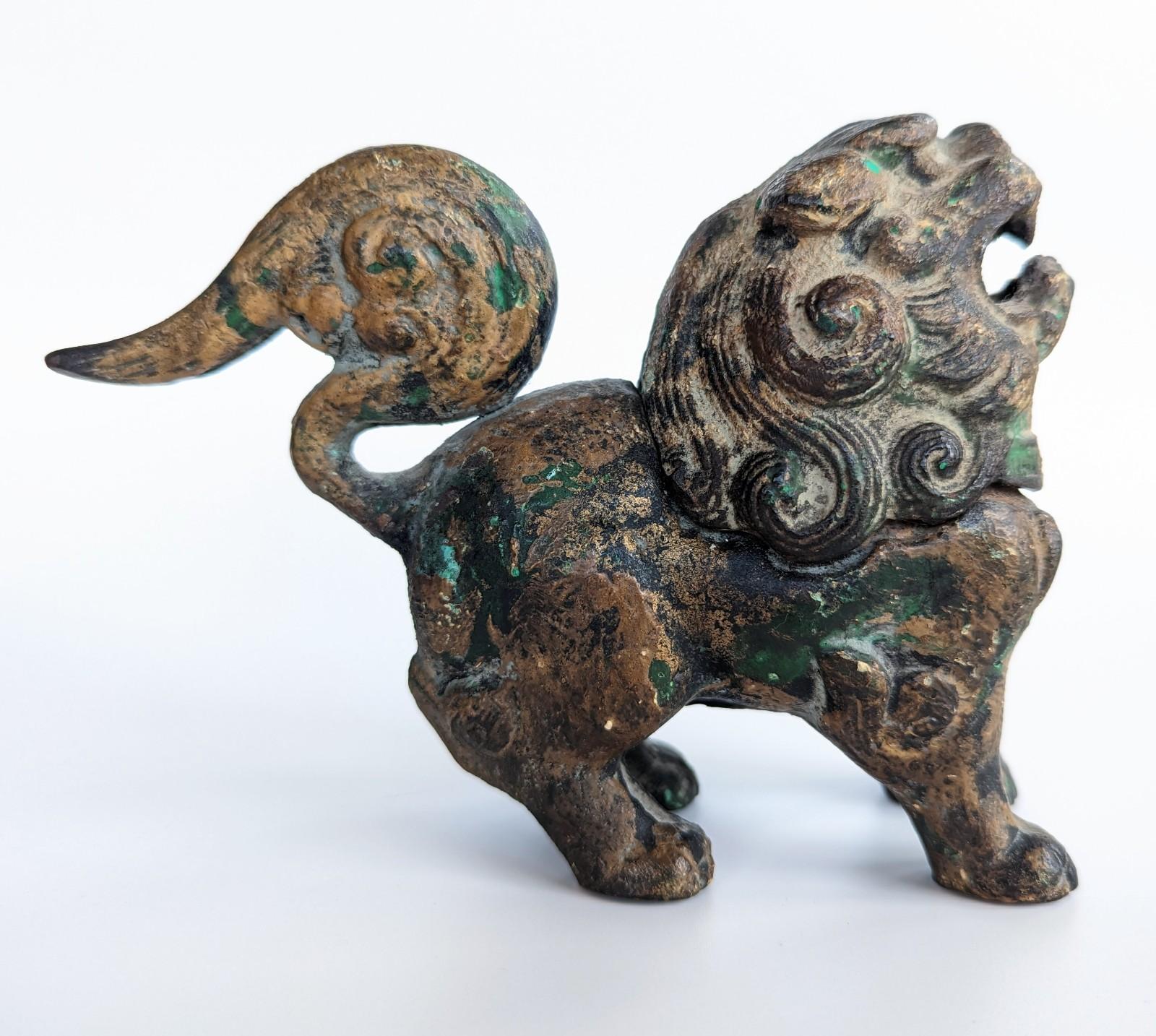 Wonderful antique patinated iron foo dog incense burner, circa early 1900s. The head is removable to load with incense.
Measures 3.75 inches in height, by 6 inches in length, by 2 inches in depth.
