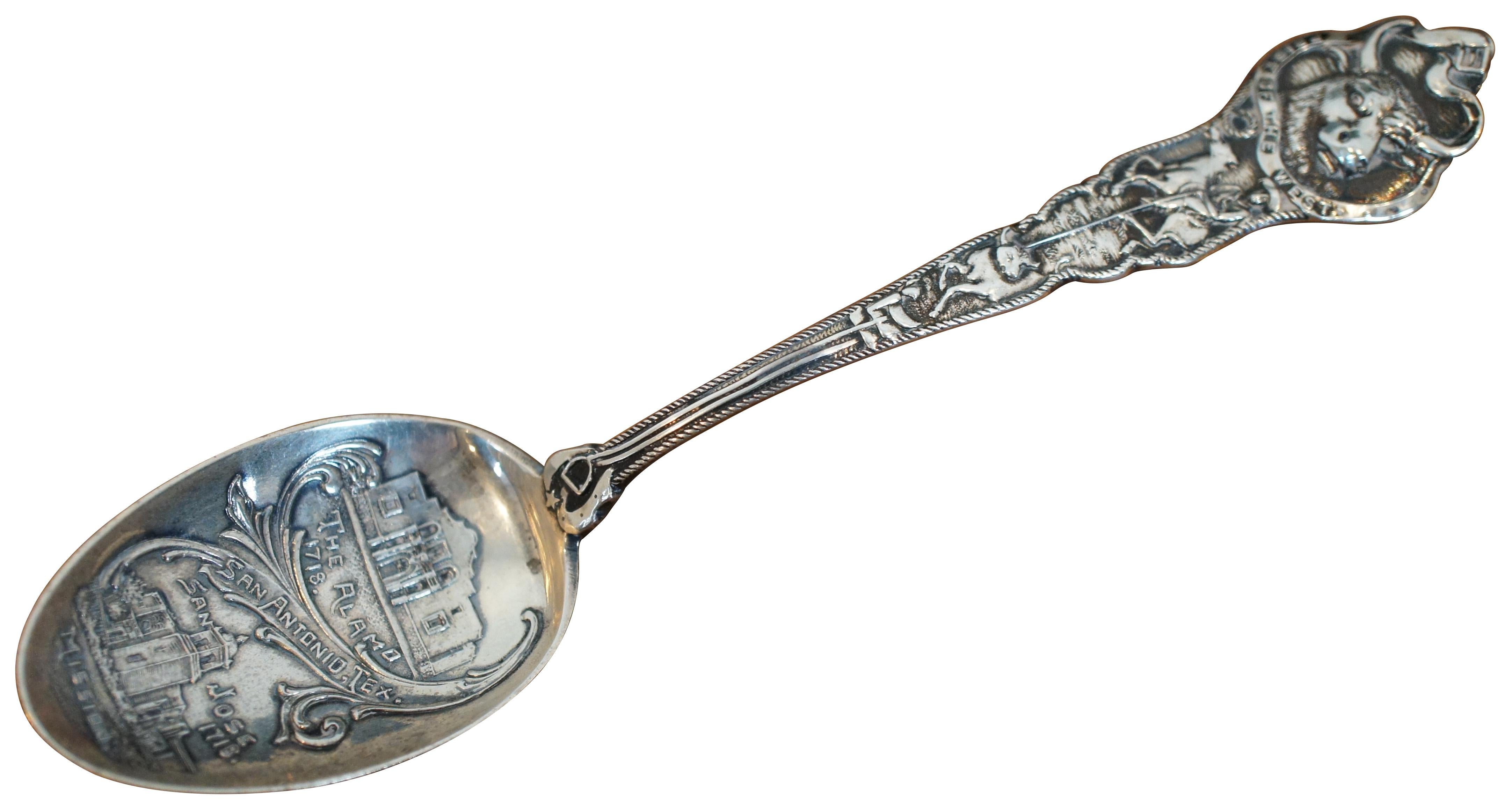 Antique early 20th century sterling silver souvenir spoon of San Antonio, Texas by Paye & Baker. The handle is topped with a bull and the phrase “Pride of the West” on a ribbon, above a handle decorated with a cowboy lassoing another bull. The bowl