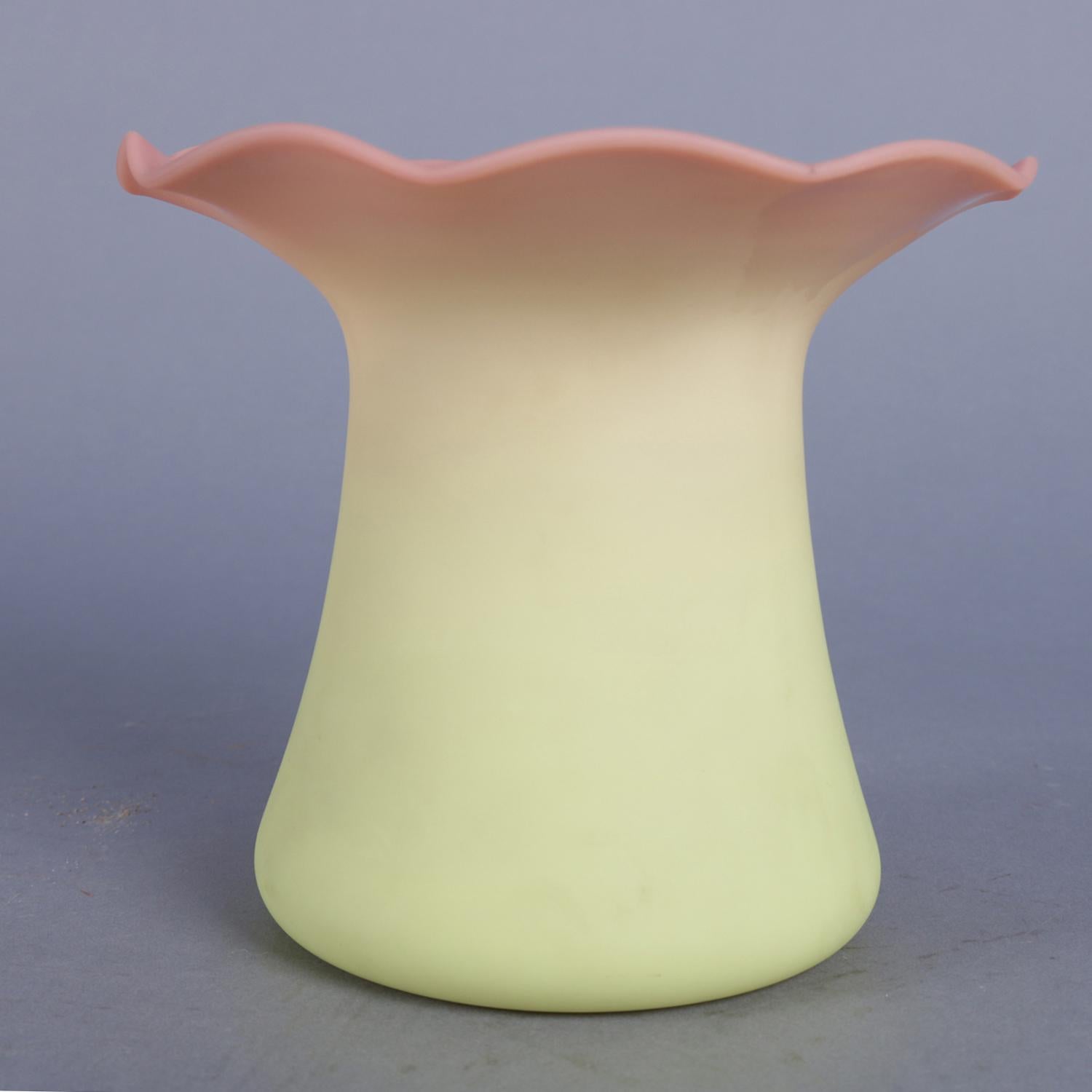 Antique Mt Washington blown vase features peach blow glass in top hat from and having ruffled rim, circa 1890.

Measures: 6