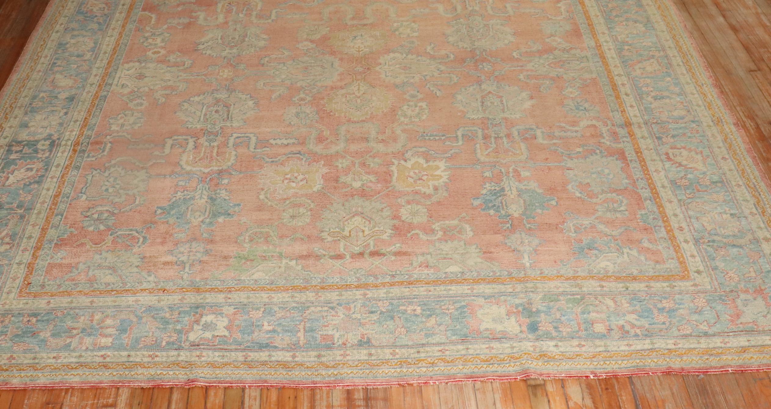 An early 20th century antique Turkish Oushak rug. Soft peach field and powder blue border.

Measures: 11'6'' x 13'.